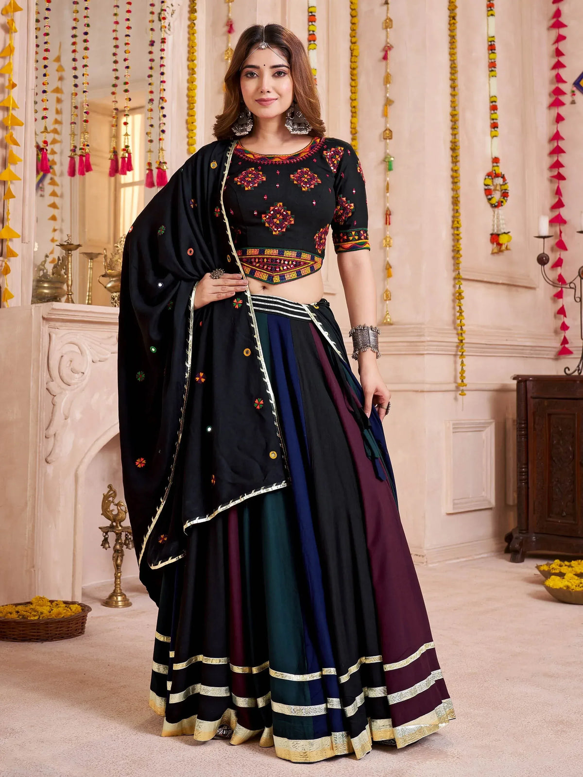 Black embroidered lehenga choli with colorful panel skirt and dupatta, perfect for Indian ethnic occasions.