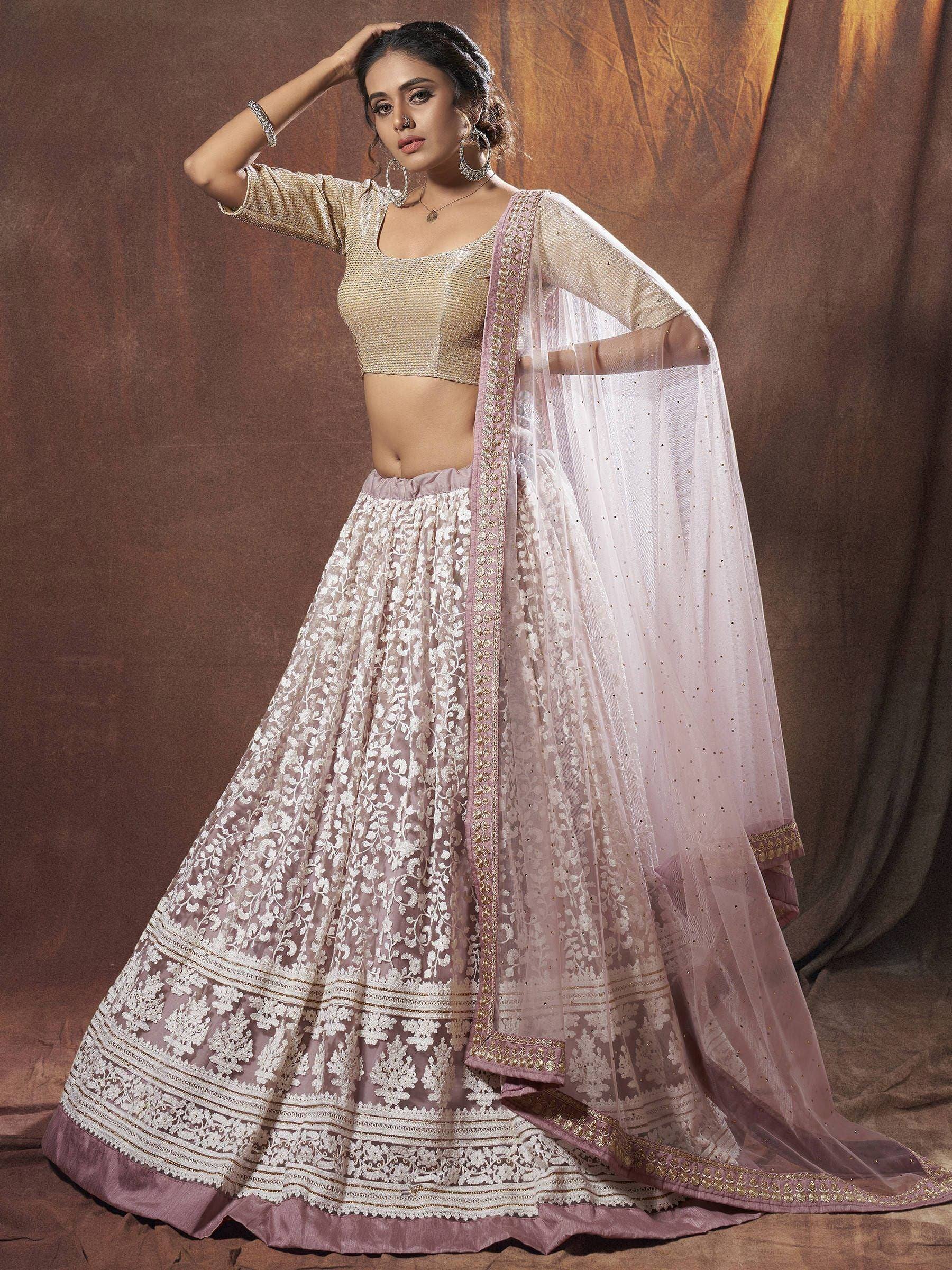 Elegant pink and gold embroidered lehenga choli with sheer dupatta, perfect for Indian weddings and festive occasions.