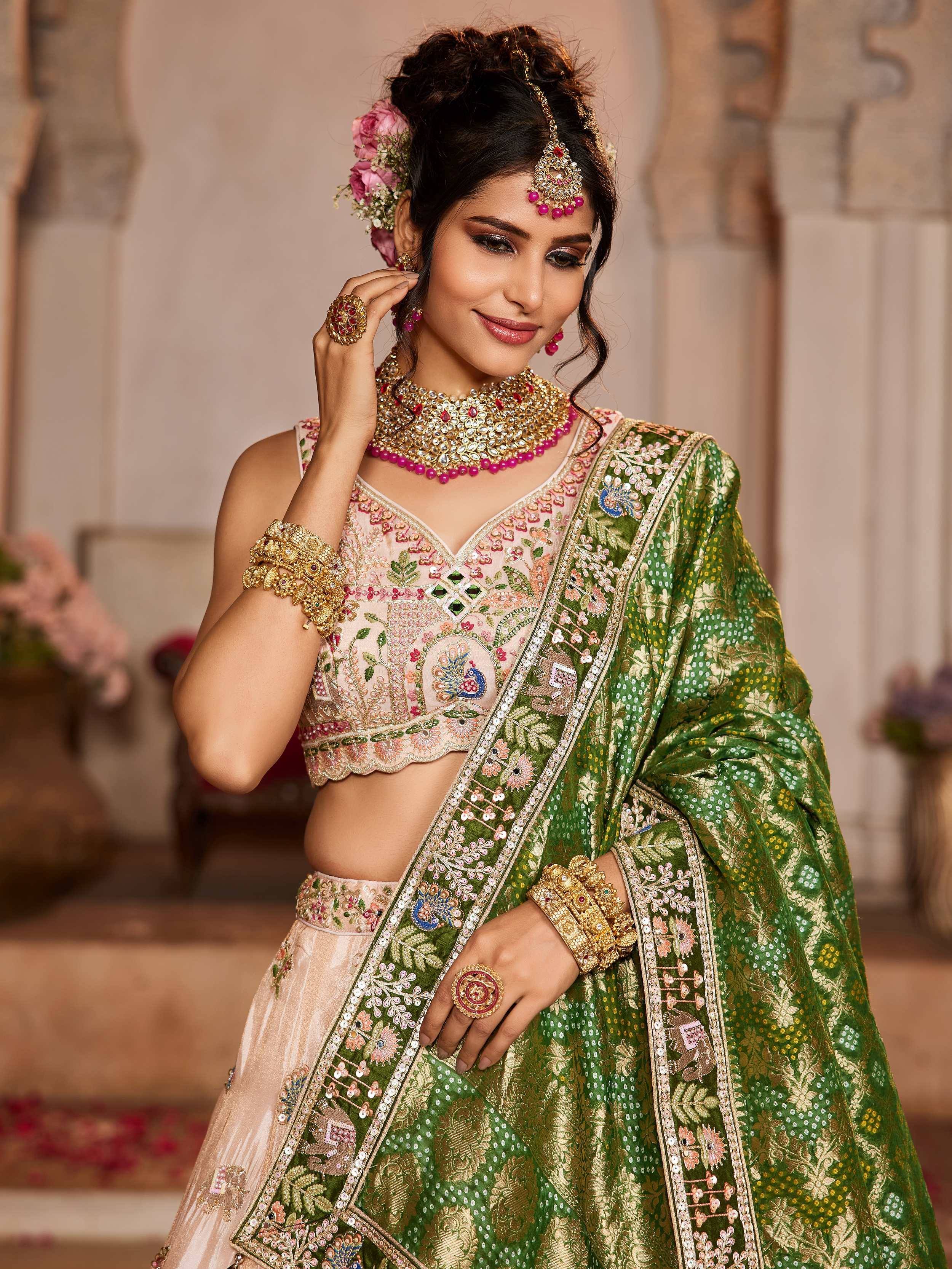 Elegant Indian ethnic wear with floral embroidery, green dupatta, and traditional jewelry