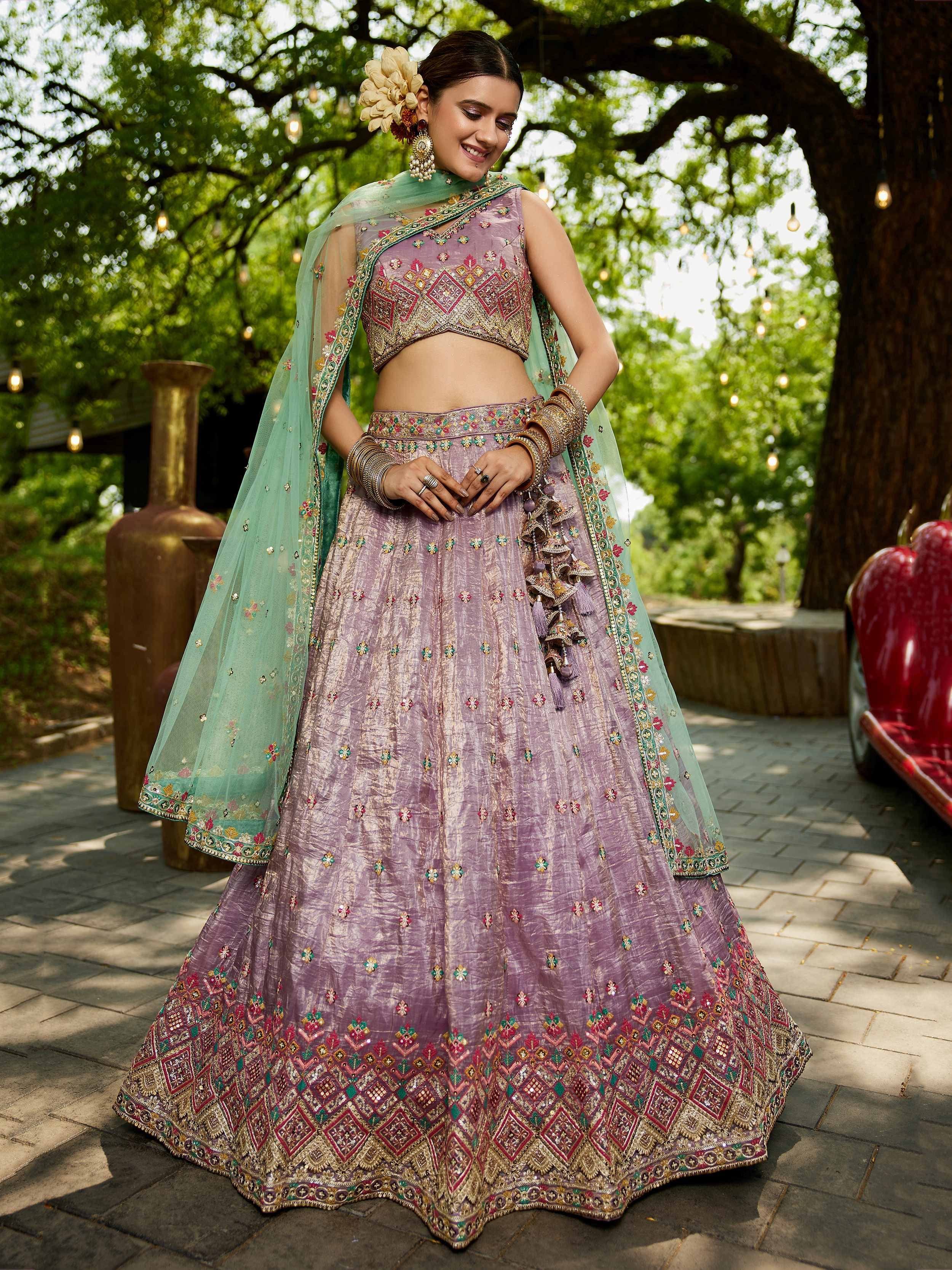 Elegant lavender lehenga choli with intricate embroidery and mint dupatta, perfect for Indian weddings and festive occasions.