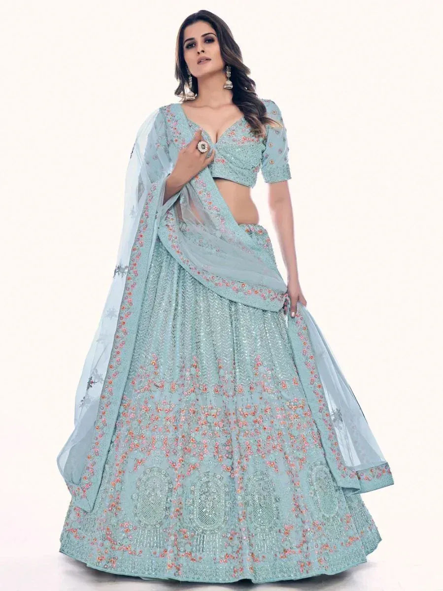 Light blue embroidered lehenga choli with floral motifs and sheer dupatta, perfect for Indian weddings and festive occasions.