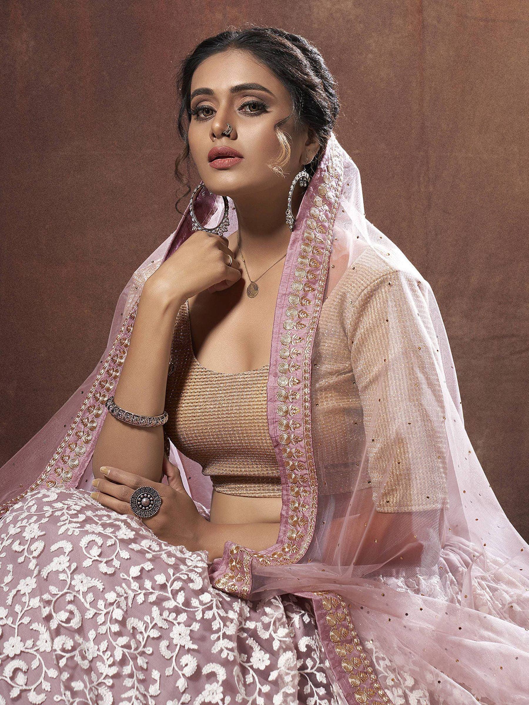 Elegant pink lehenga choli with gold embroidery and sheer dupatta, perfect for Indian ethnic wear occasions