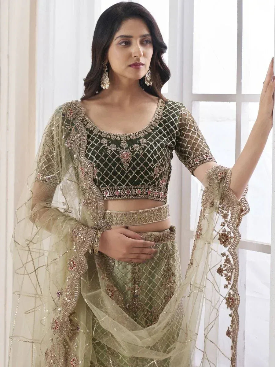 Elegant olive green designer lehenga choli with gold embroidery and sheer dupatta, perfect for Indian ethnic occasions.