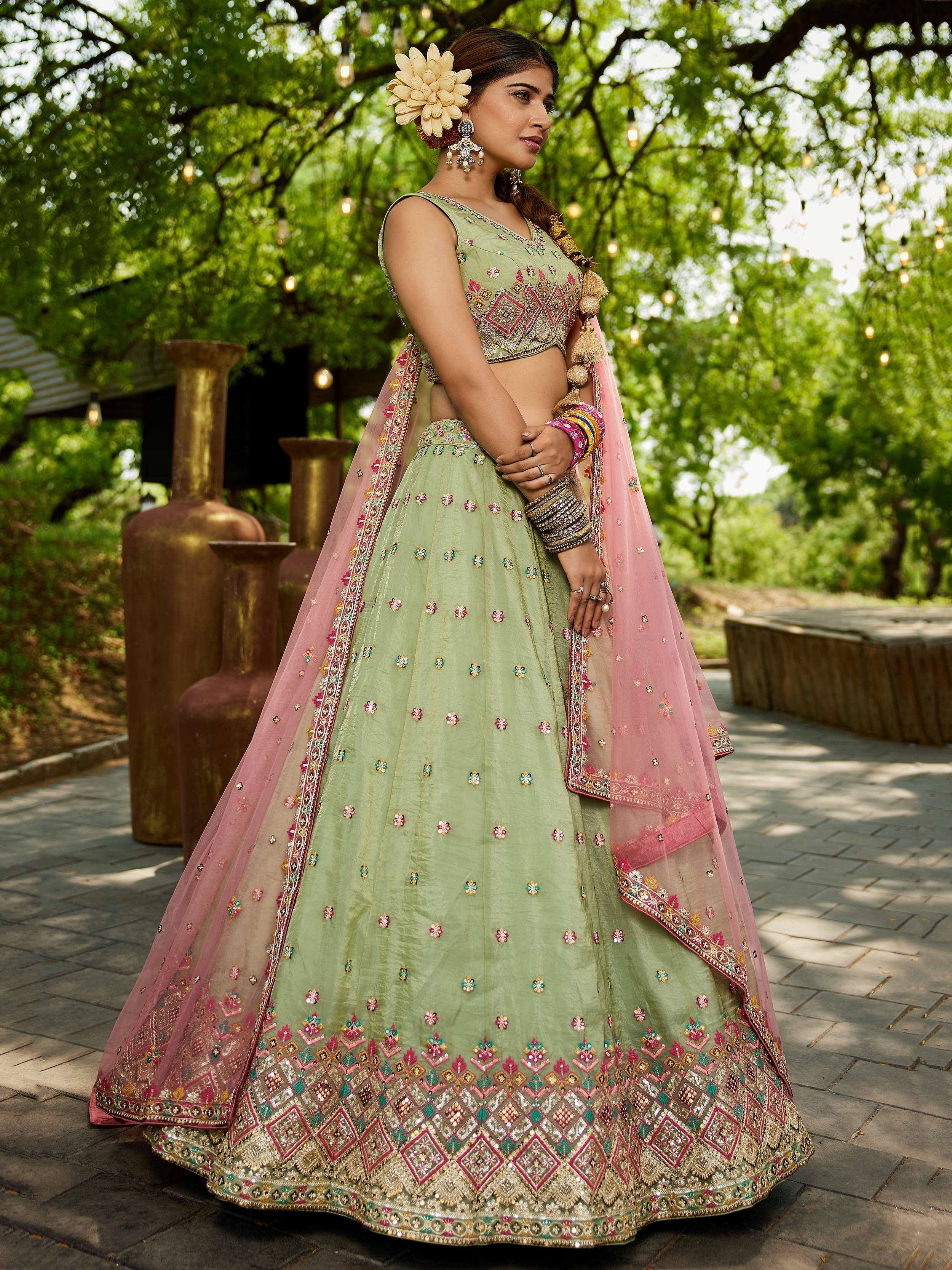 Mint green embroidered lehenga choli with pink dupatta, perfect for Indian weddings and festive occasions.