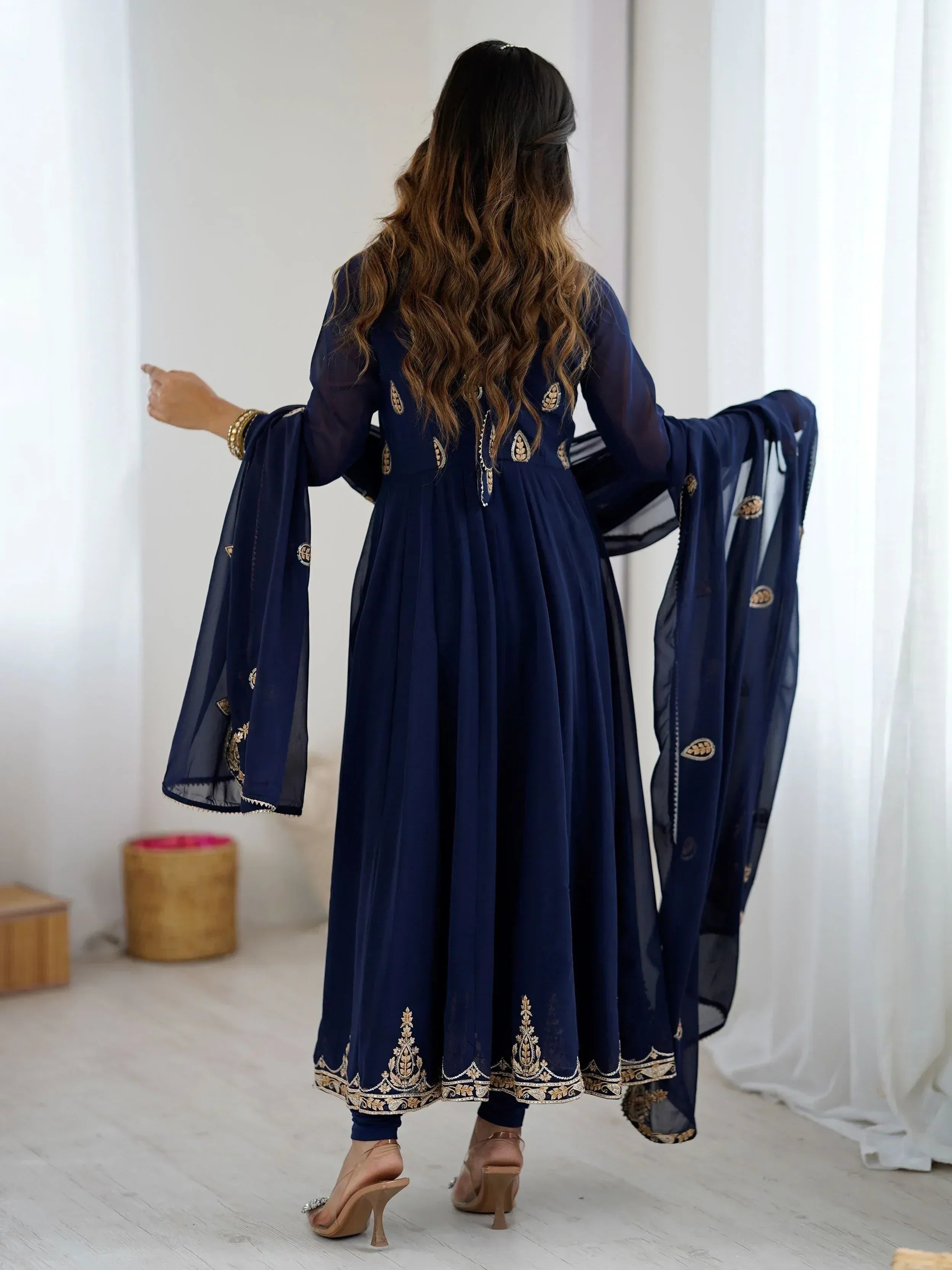 Navy blue embroidered anarkali suit with gold detailing, sheer dupatta, and flared sleeves for Indian ethnic wear