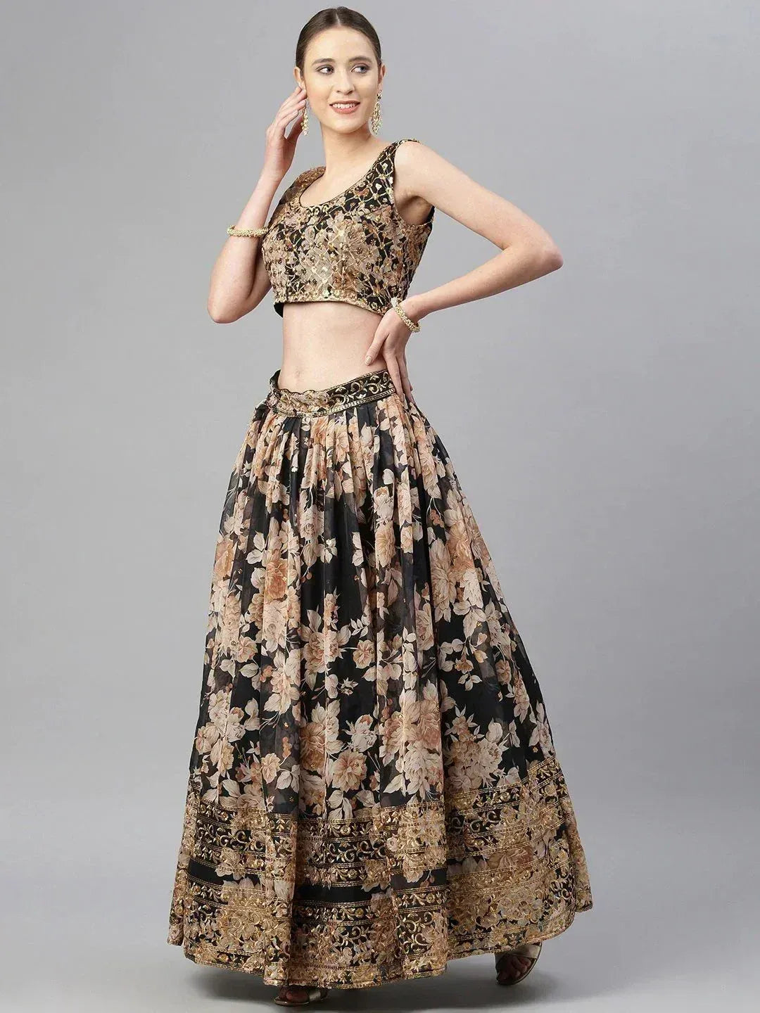 Black and gold floral lehenga choli with embroidered crop top and flared skirt, perfect for Indian ethnic occasions.