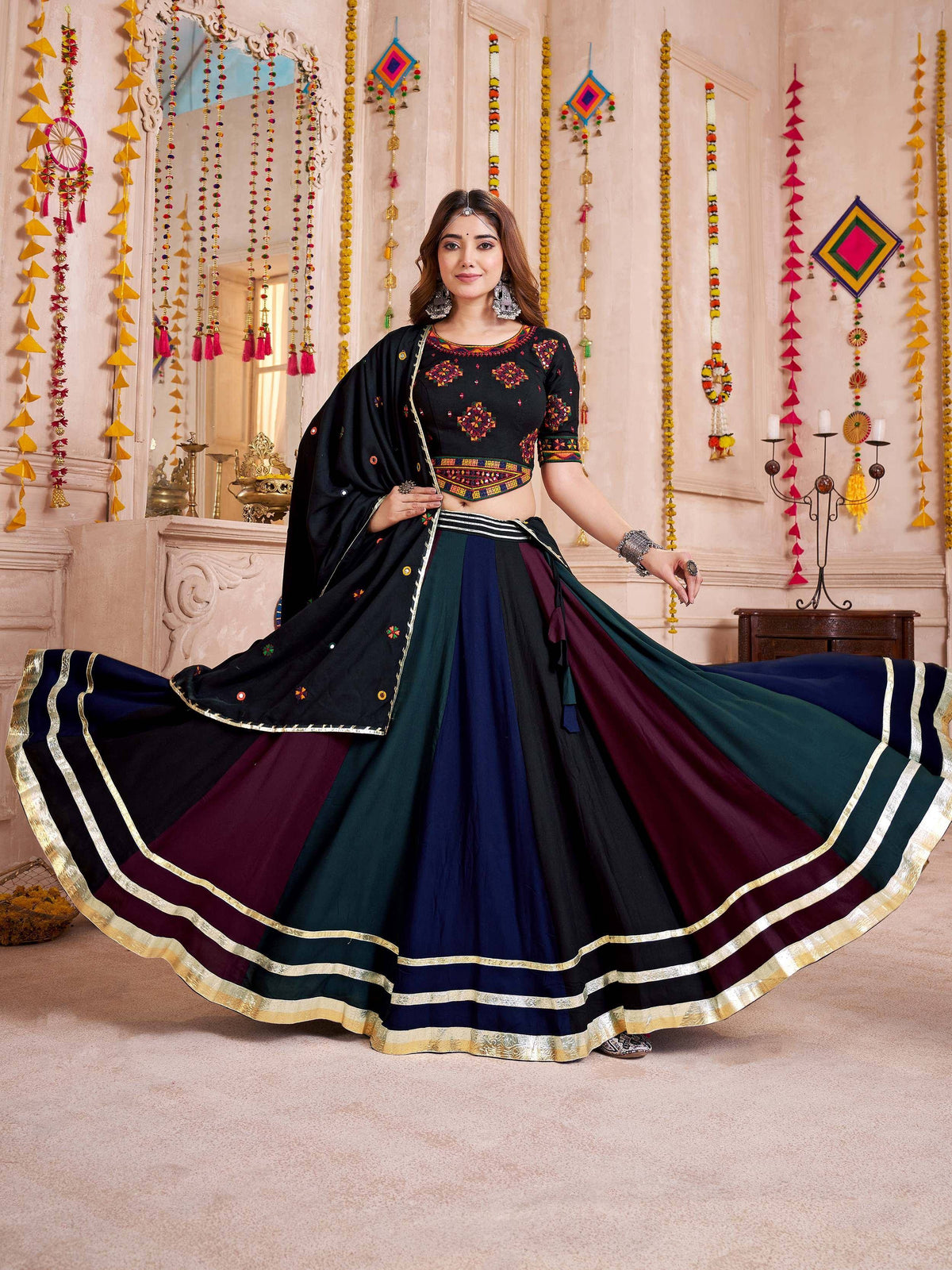 Black embroidered lehenga choli with multi-color skirt and gold border, perfect for Indian ethnic wear.