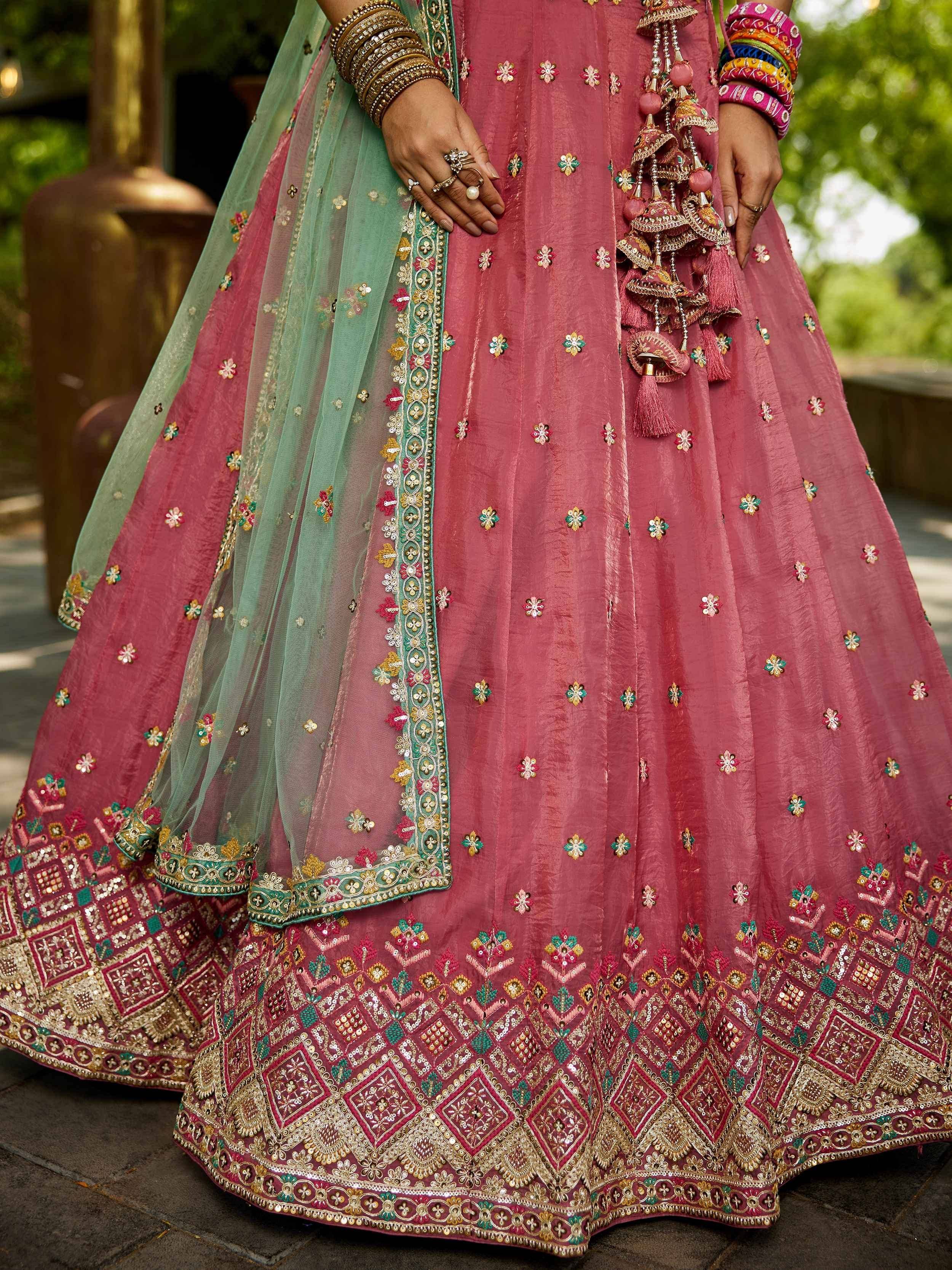 Pink embroidered lehenga choli with green dupatta, traditional Indian ethnic wear for weddings and festivals