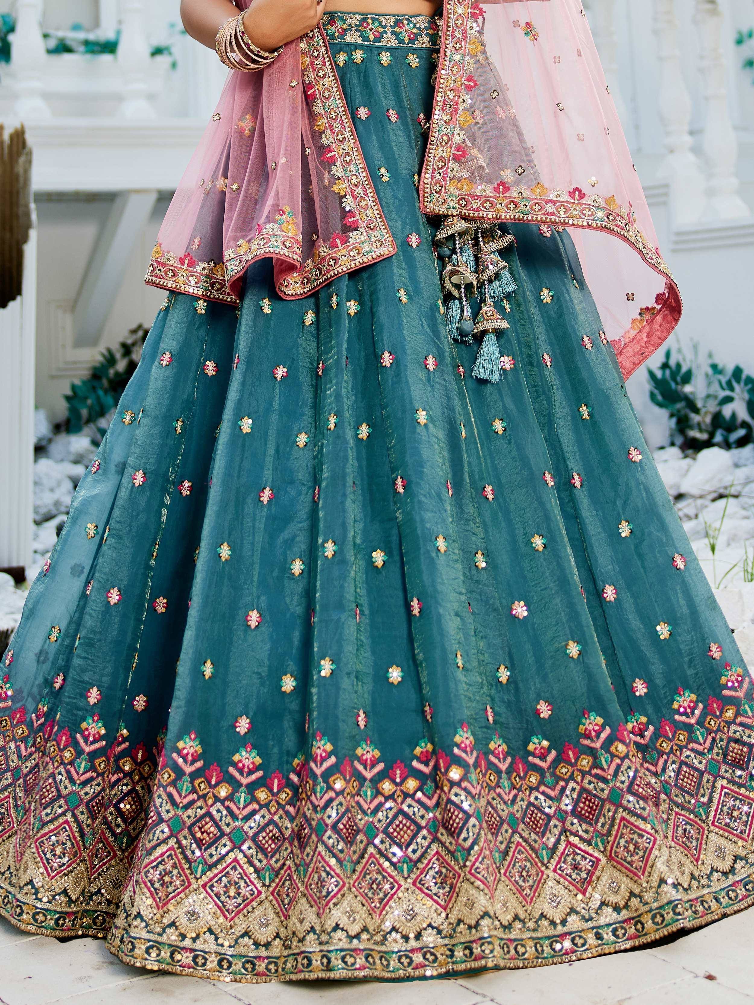 Teal lehenga choli with pink dupatta, floral embroidery, and mirror work for Indian ethnic wear
