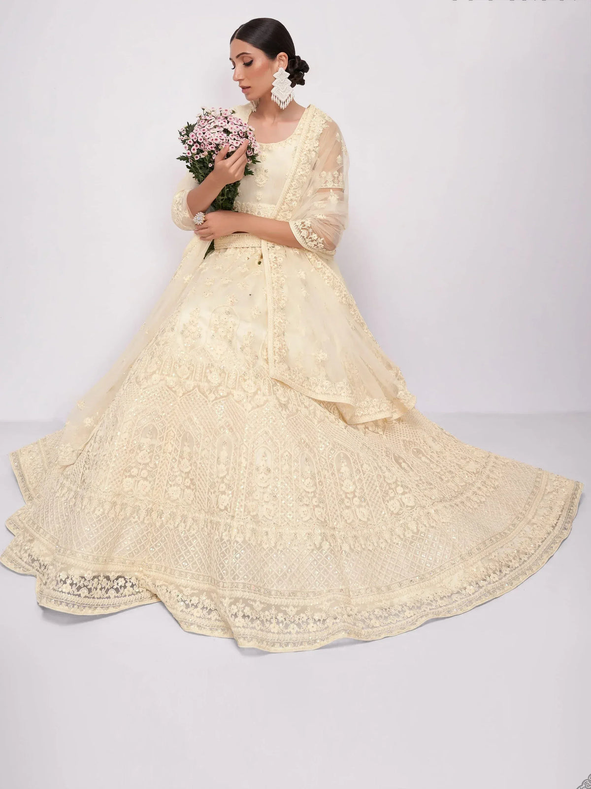 Elegant cream designer lehenga choli with intricate embroidery and floral bouquet