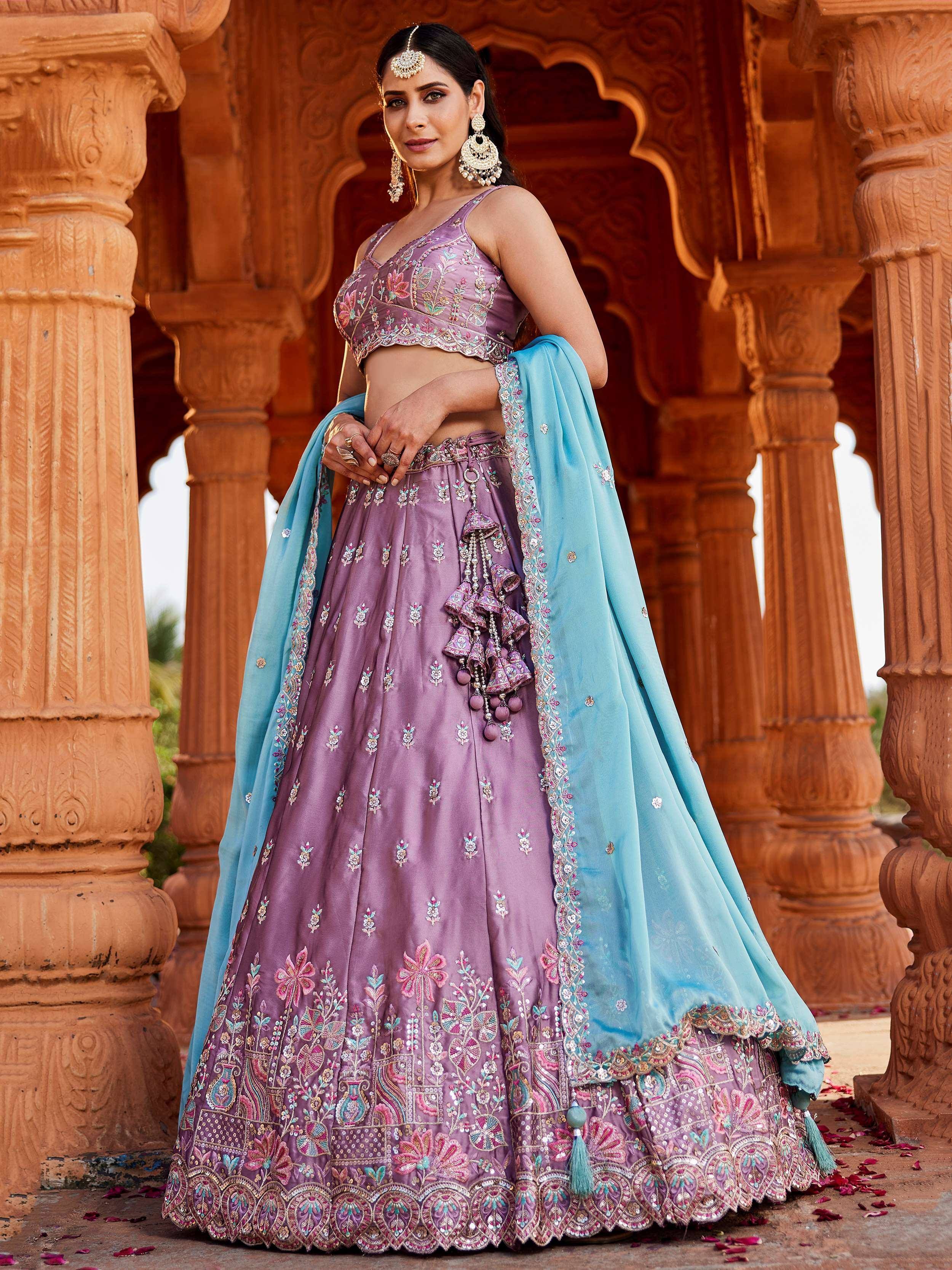 Purple embroidered lehenga choli with blue dupatta, perfect for Indian weddings and festive occasions.
