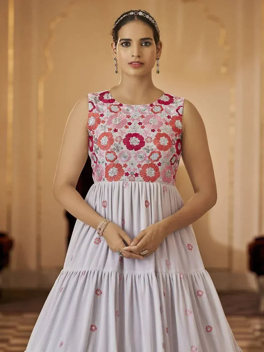 Floral embroidered ethnic gown in pastel pink with tiered skirt, perfect for Indian celebrations
