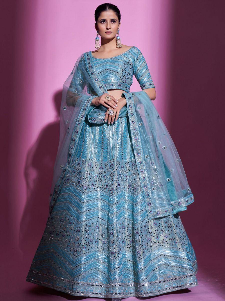 Light blue designer lehenga choli with intricate embroidery and sequins, perfect for weddings and festive occasions.