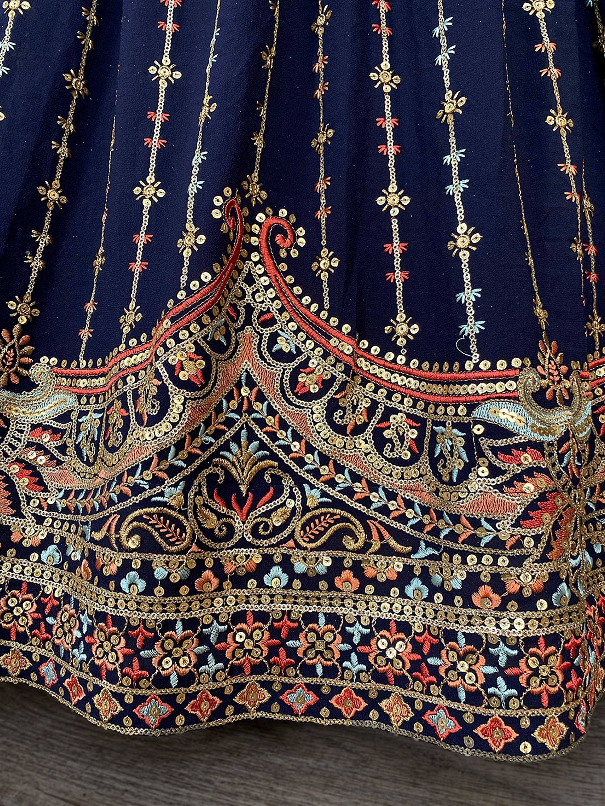 Navy blue ethnic lehenga with gold, red, and blue floral embroidery and sequin detailing