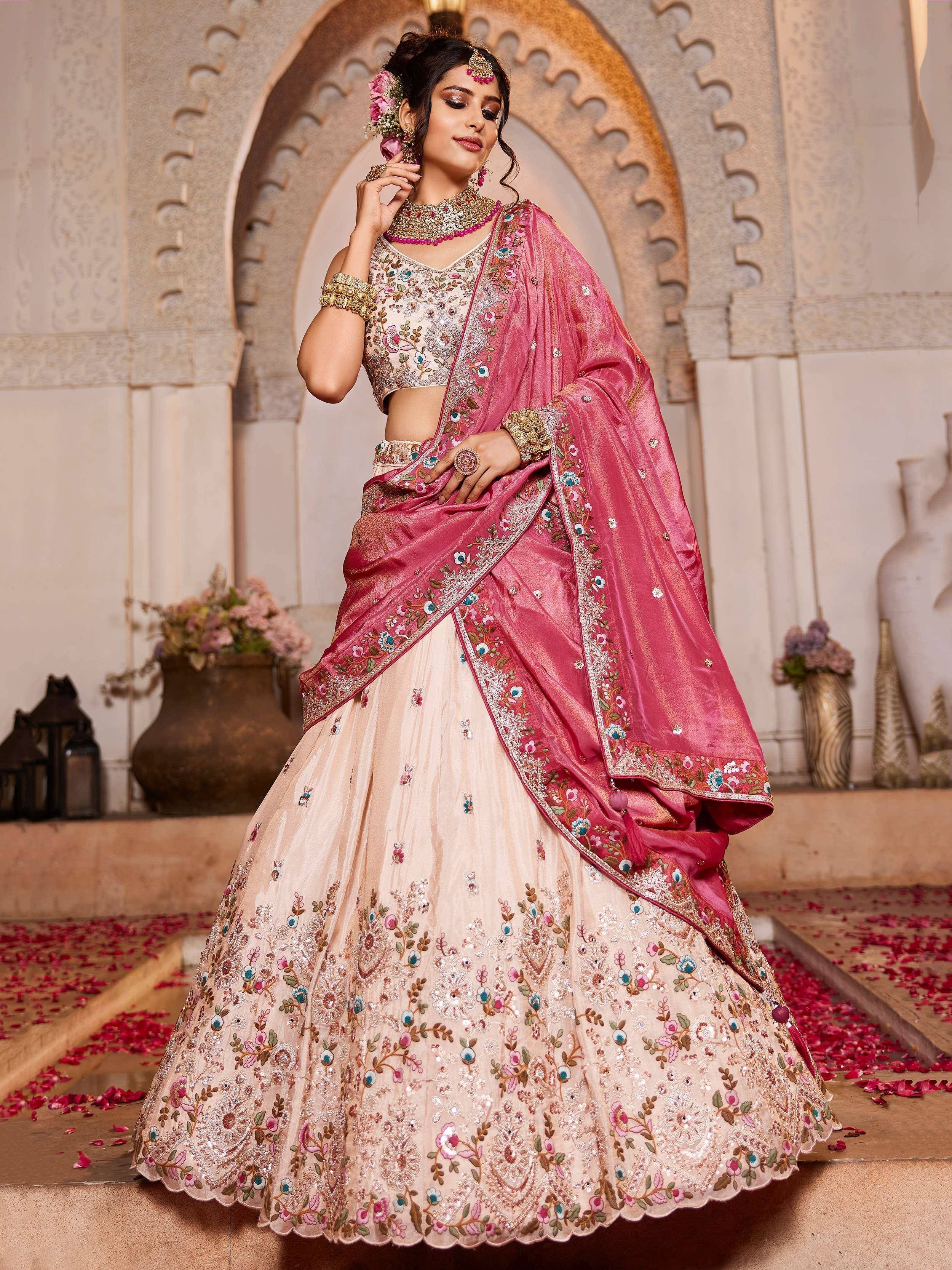 Elegant pink and beige embroidered lehenga choli with floral designs, perfect for Indian ethnic wear.