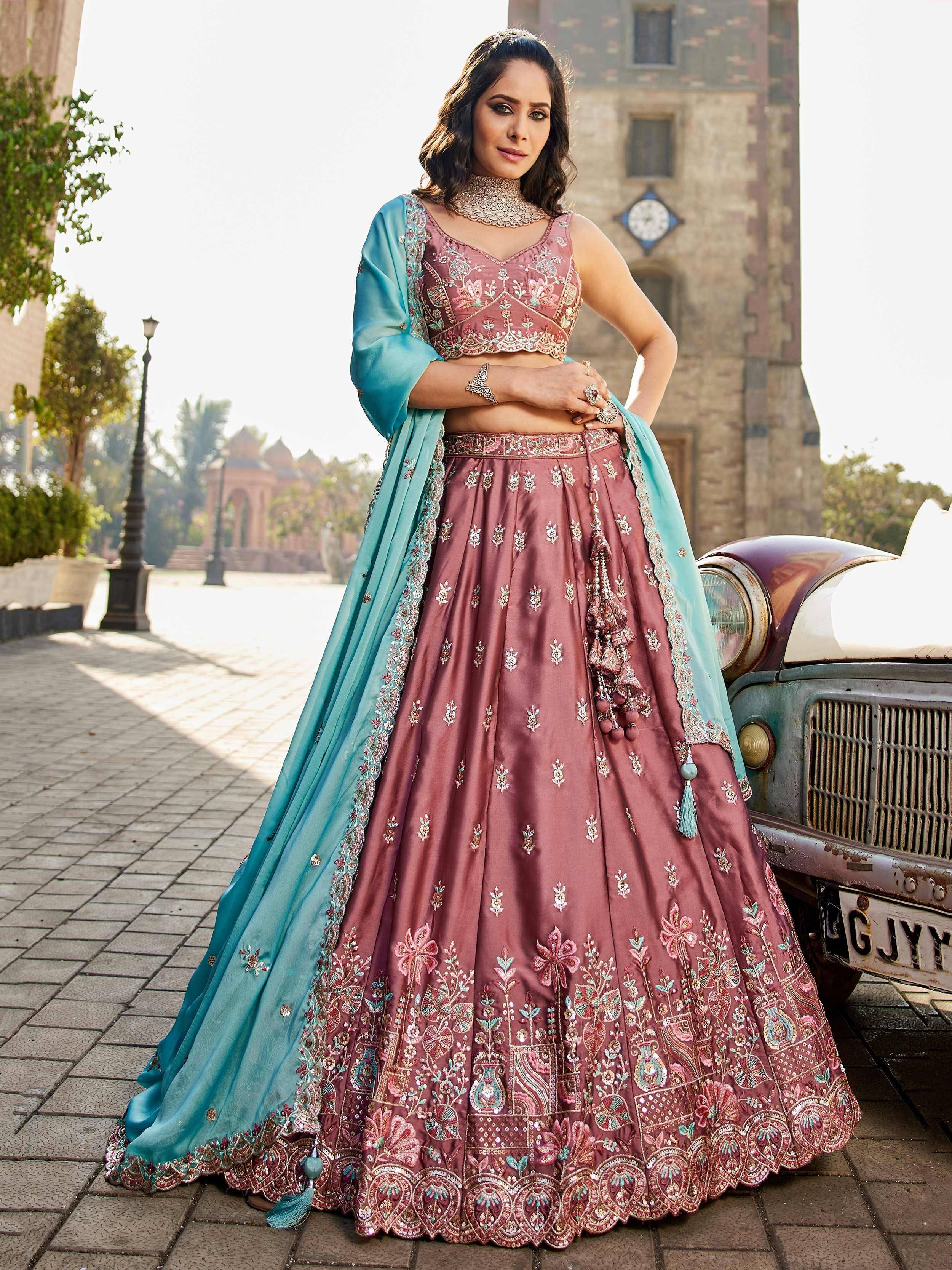 Elegant mauve lehenga choli with turquoise dupatta, intricate floral embroidery, perfect for Indian weddings or festive occasions.