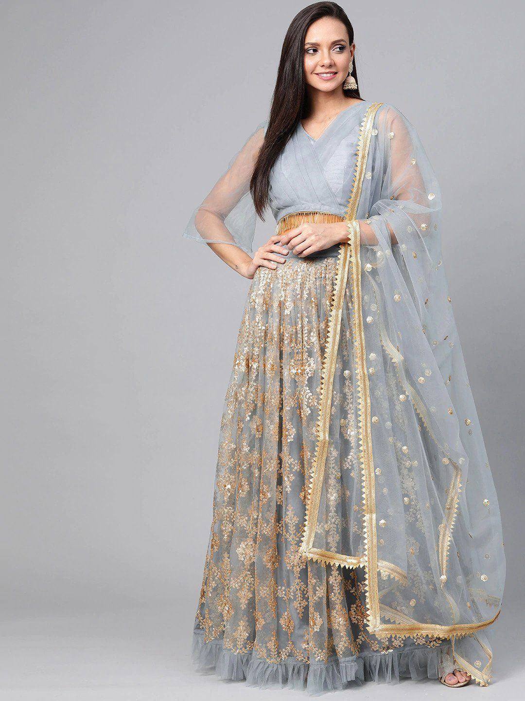 Light blue embroidered lehenga choli with gold detailing and sheer dupatta, perfect for Indian ethnic wear occasions.