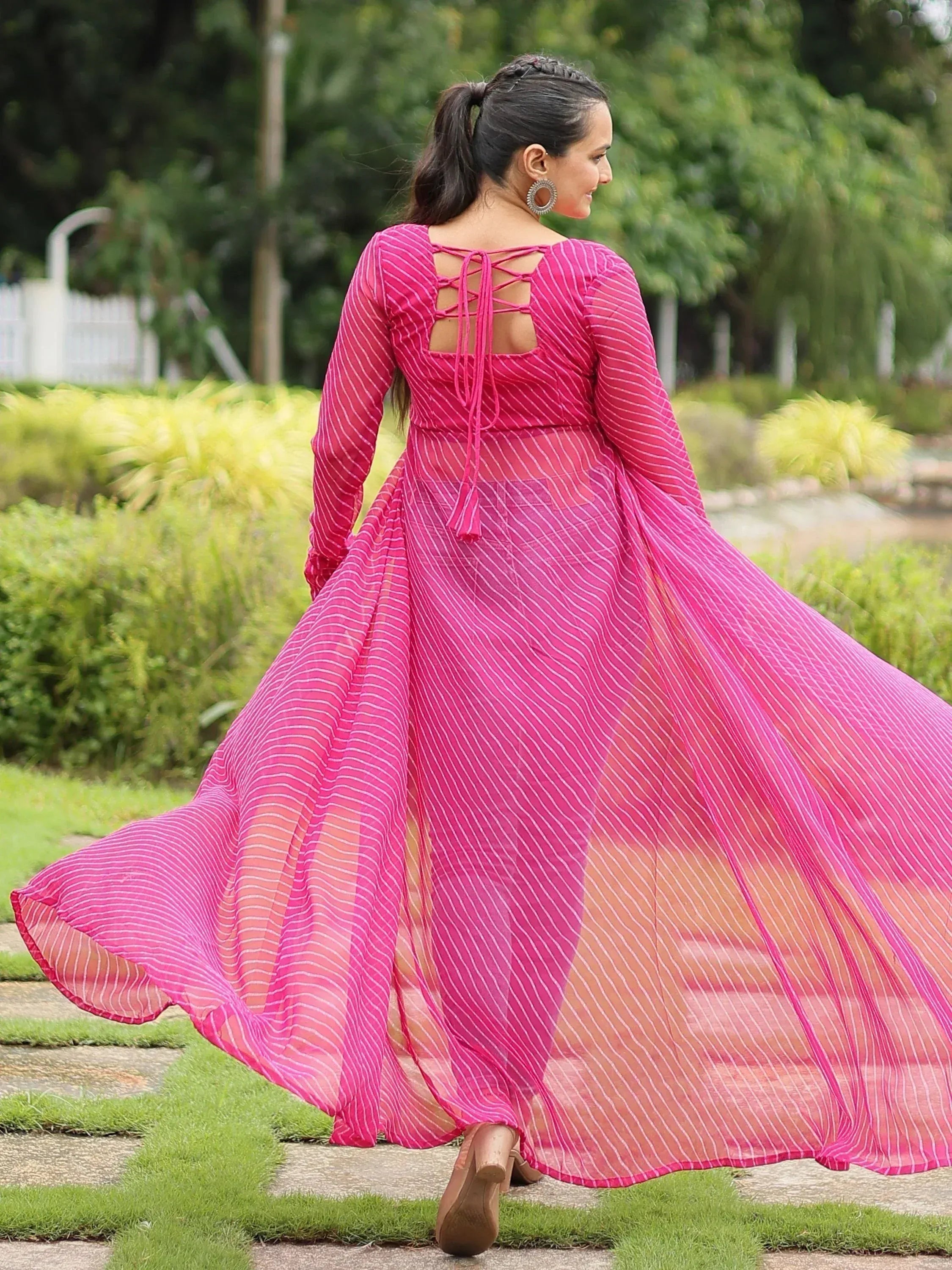Pink striped ethnic gown with lace-up back, flowing skirt, and long sleeves for women