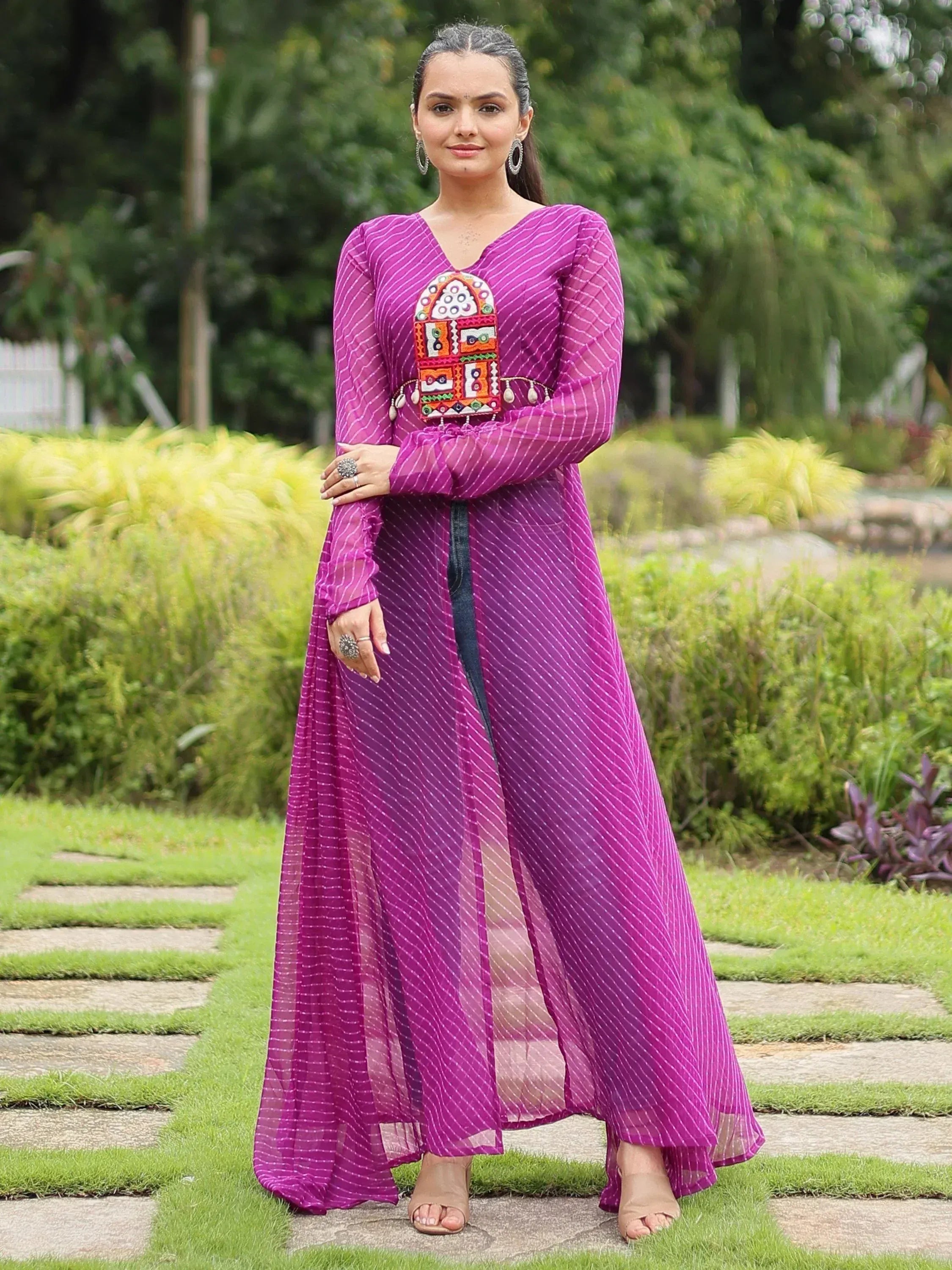 Purple ethnic gown with mirror work, long sleeves, and side slit, perfect for Indian occasions