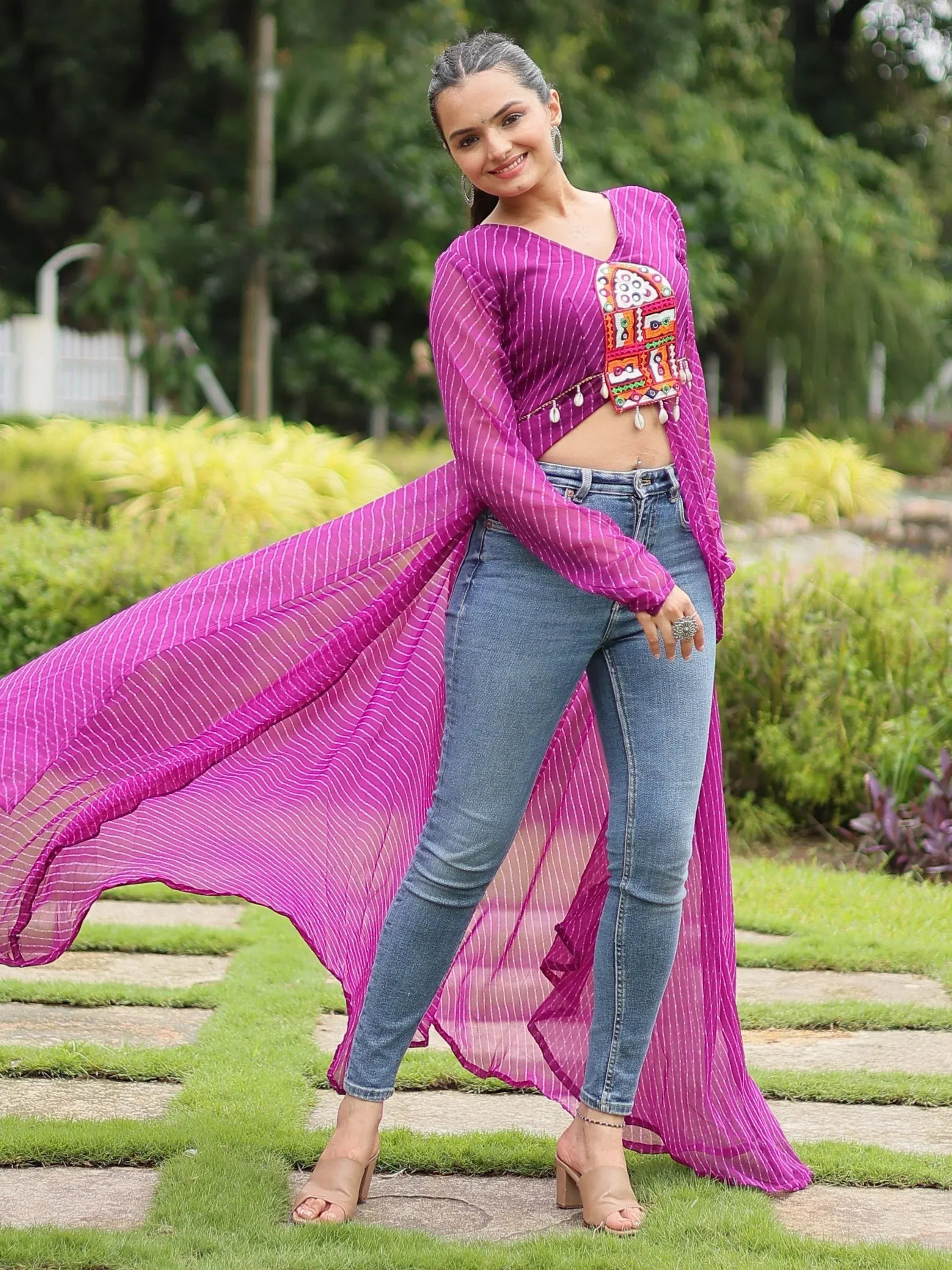 Purple striped ethnic crop top with mirror work, paired with jeans, perfect for fusion wear