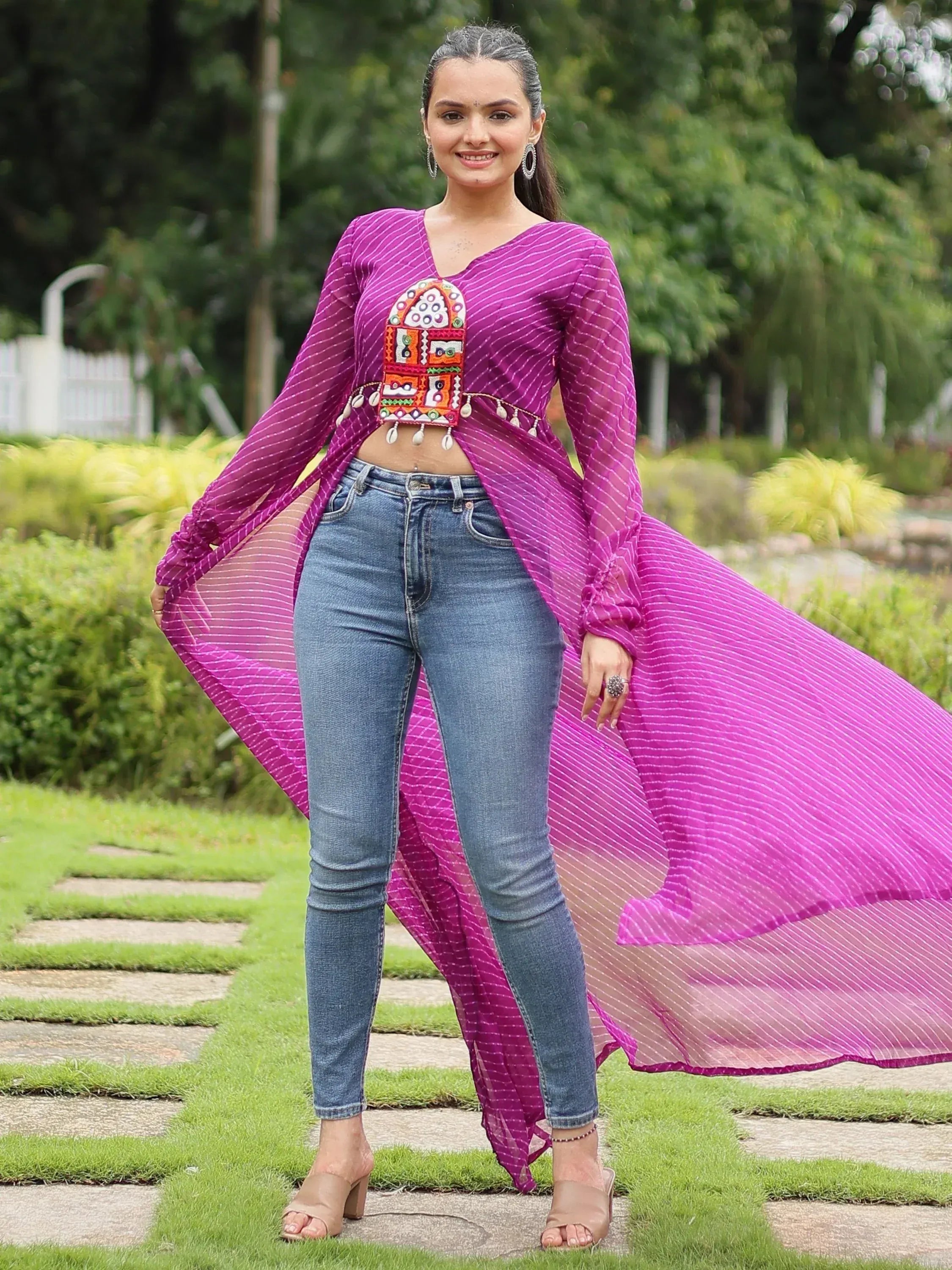 Purple striped ethnic crop top with mirror work, paired with jeans, perfect for fusion wear