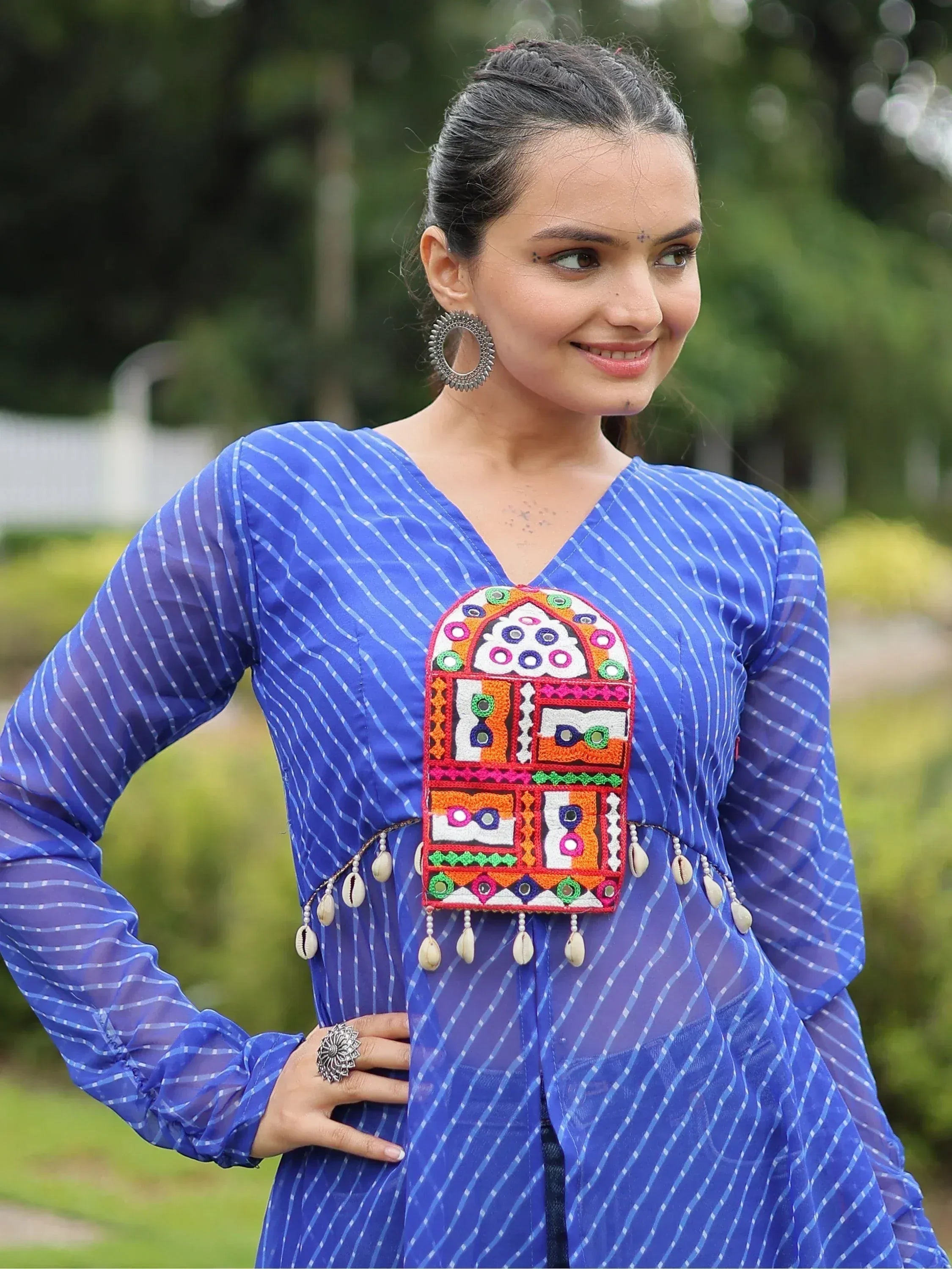 Blue striped ethnic kurti with colorful mirror embroidery and shell tassels, perfect for Indian wear.