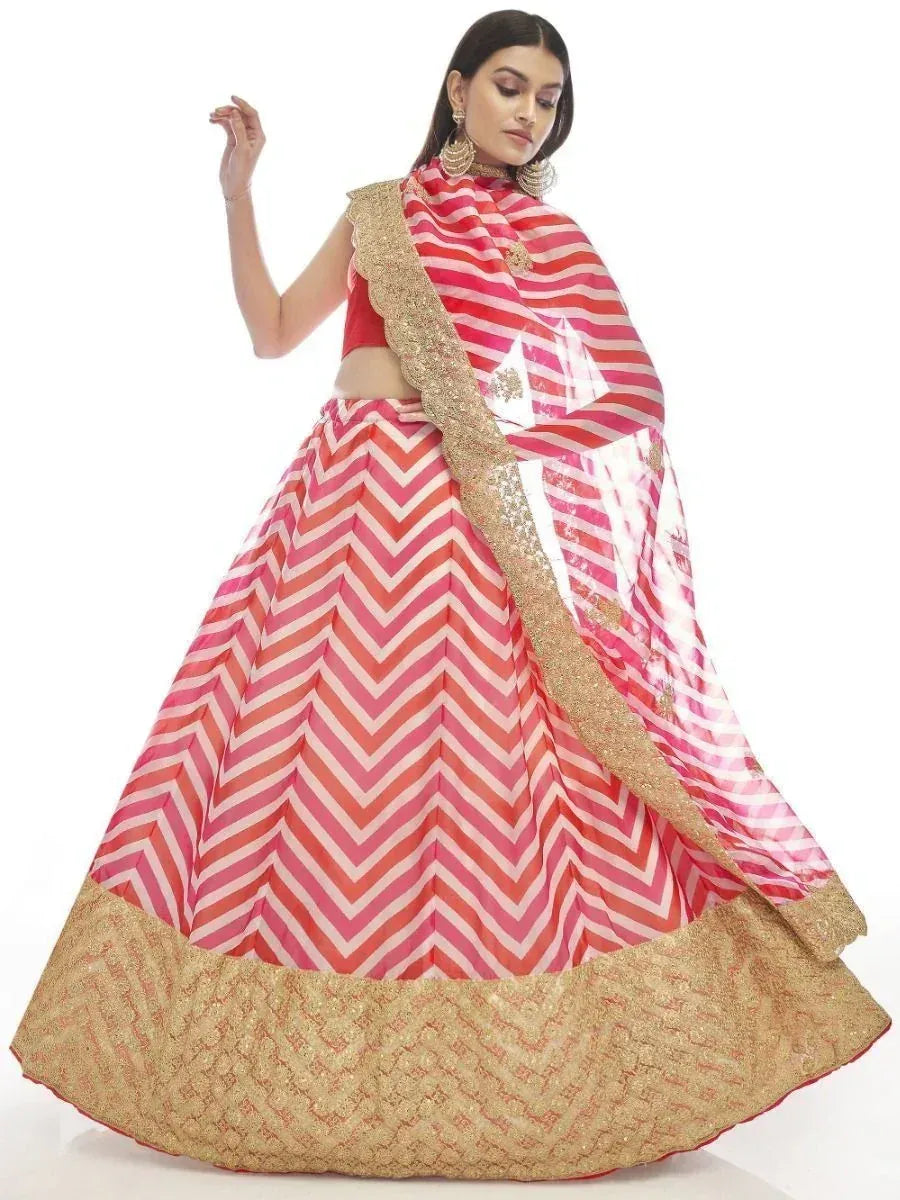 Pink and gold chevron print lehenga choli with embroidered border, perfect for Indian ethnic wear occasions