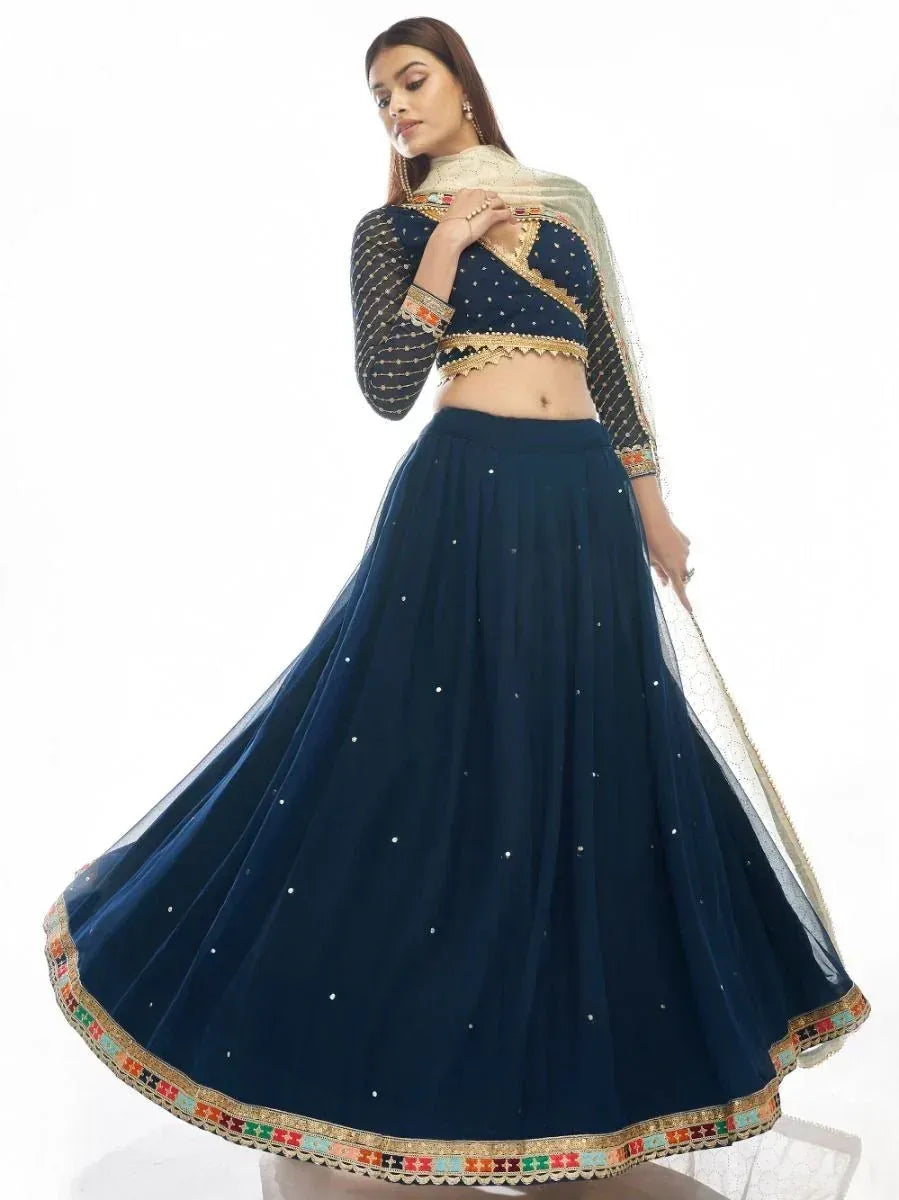 Navy blue designer lehenga choli with gold embroidery and colorful border, perfect for Indian ethnic occasions