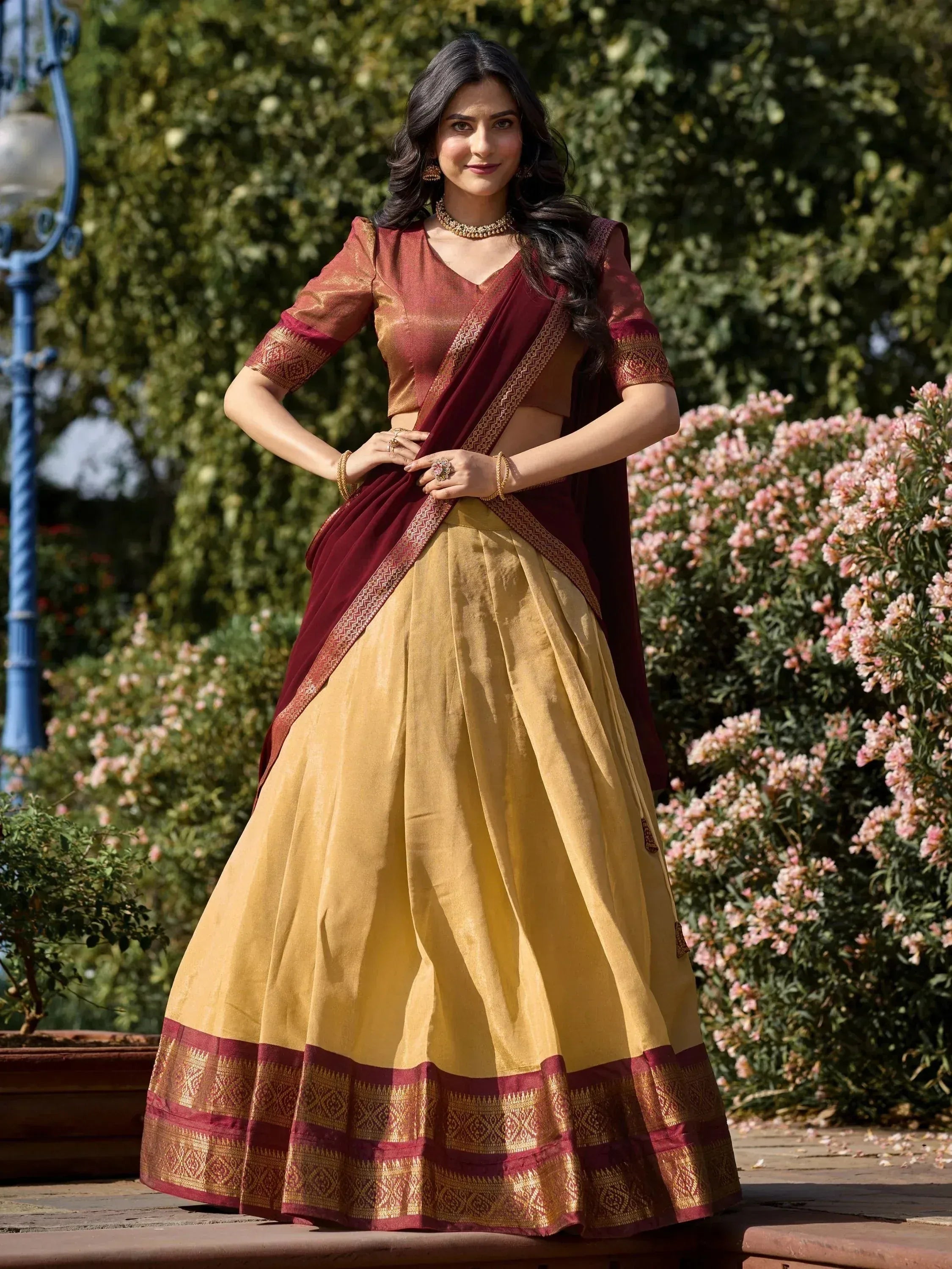 Maroon and gold designer lehenga choli with intricate border, perfect for Indian ethnic wear occasions