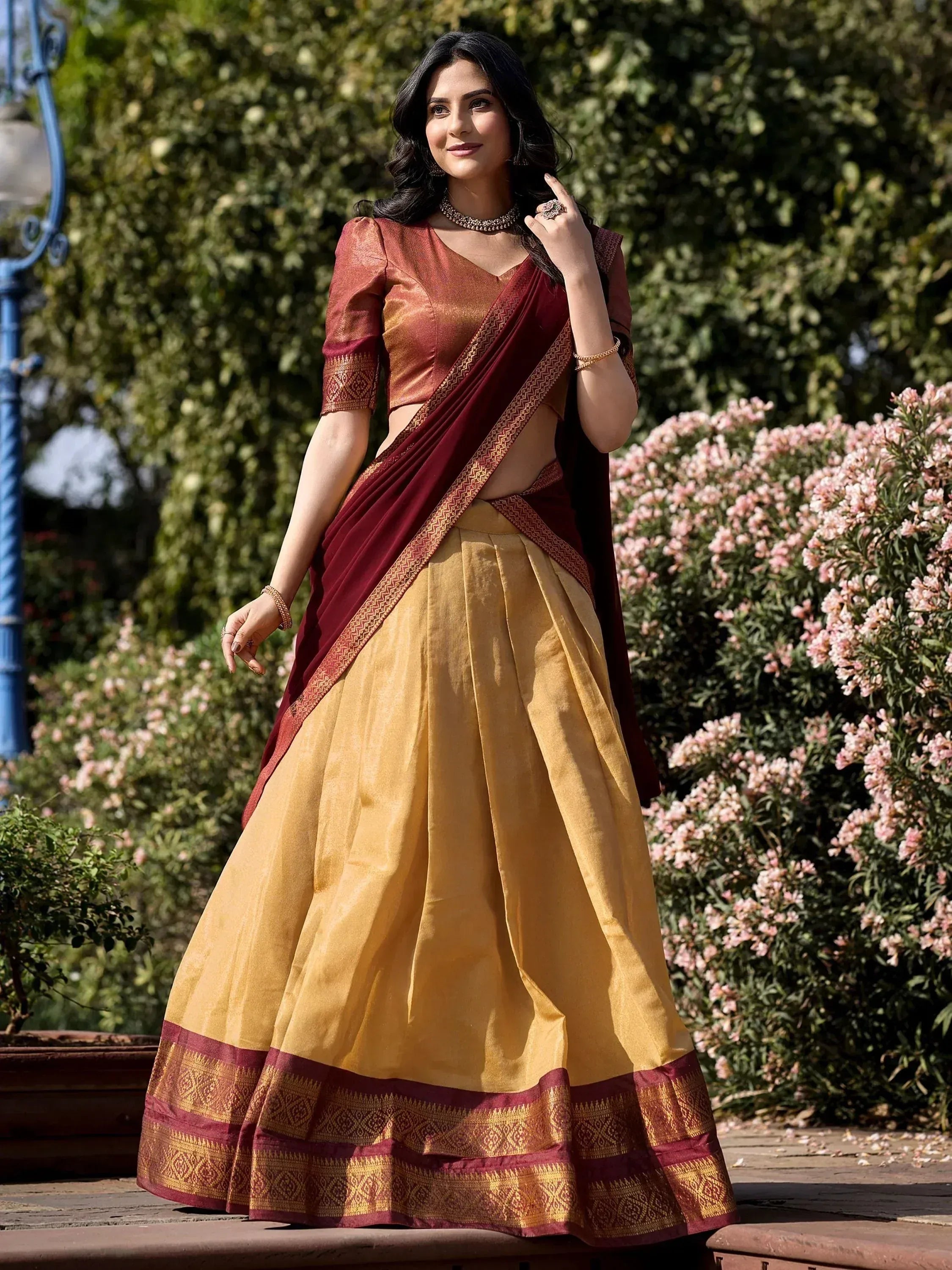 Maroon and gold designer lehenga choli with intricate border, perfect for Indian ethnic wear occasions