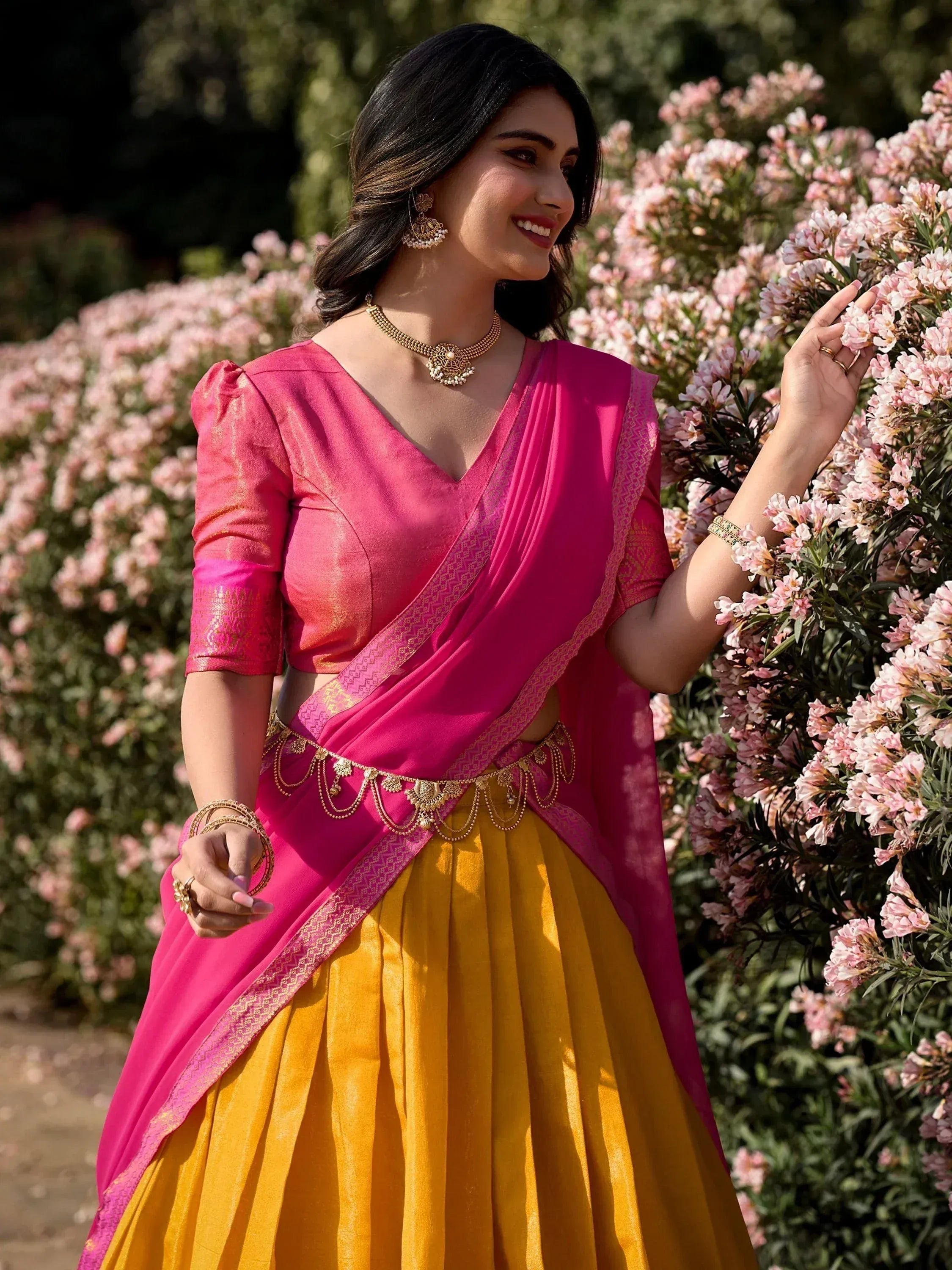 Pink and yellow designer lehenga choli with gold embroidery, perfect for Indian ethnic wear occasions.