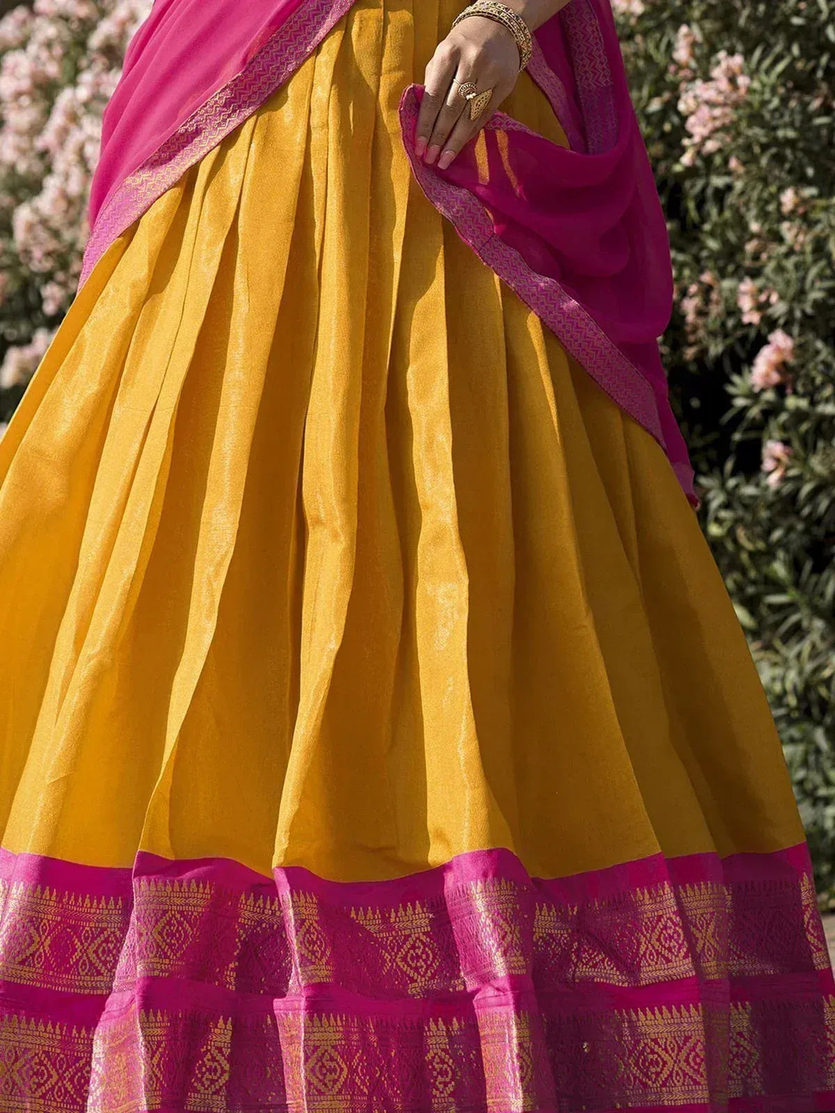 Yellow and pink ethnic lehenga with embroidered border, perfect for Indian weddings and festivals