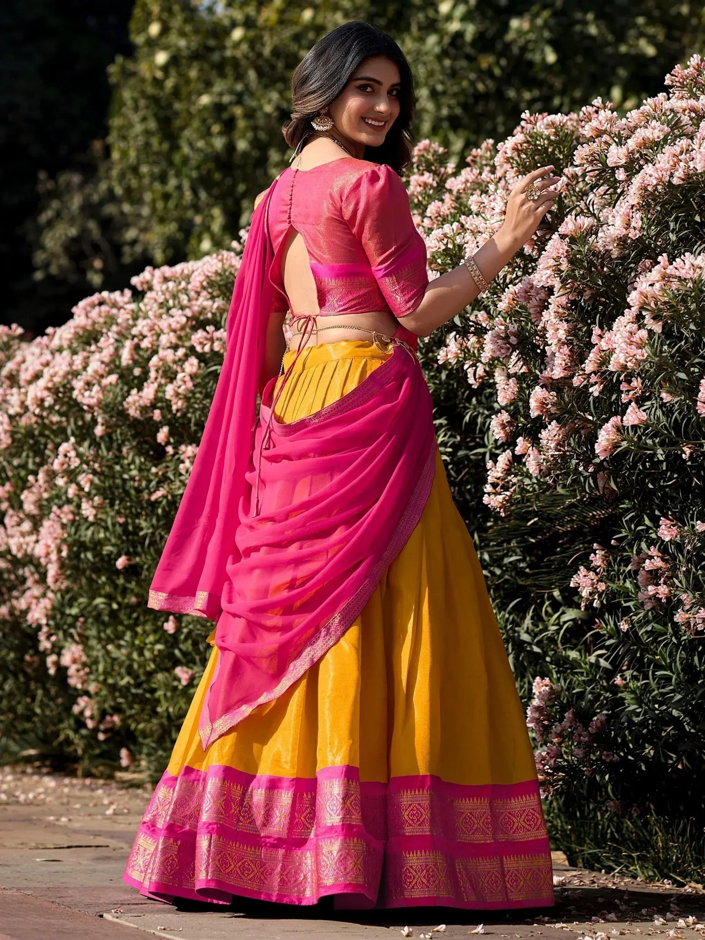Pink and yellow designer lehenga choli with back cutout, perfect for Indian ethnic wear occasions