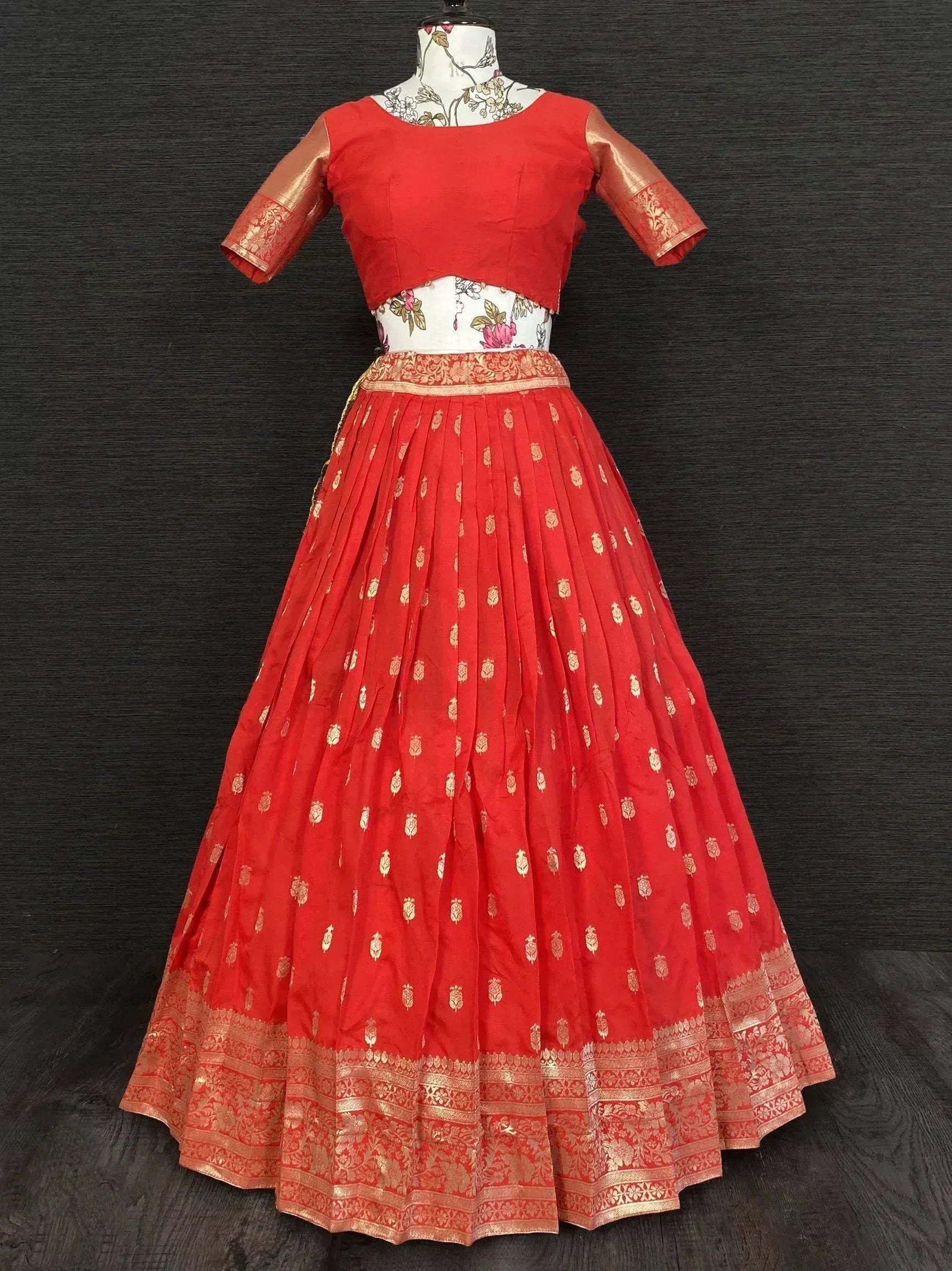 Red designer lehenga choli with gold embroidery, perfect for Indian ethnic wear and festive occasions.