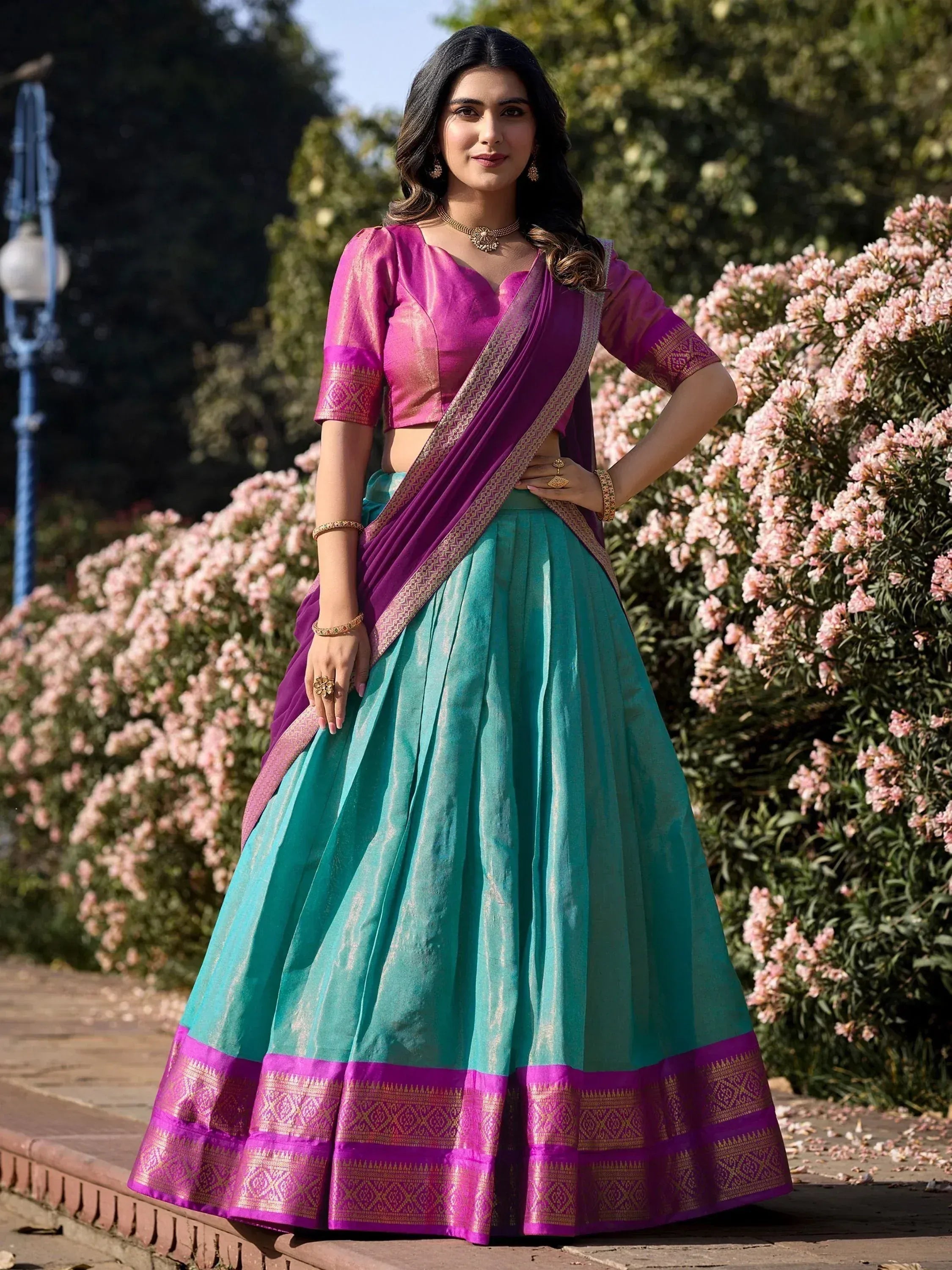 Teal and magenta lehenga choli with gold border, perfect for Indian ethnic wear occasions