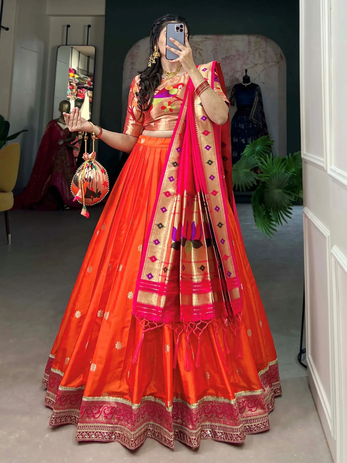Vibrant orange lehenga choli with floral embroidery and pink dupatta, perfect for Indian ethnic wear occasions