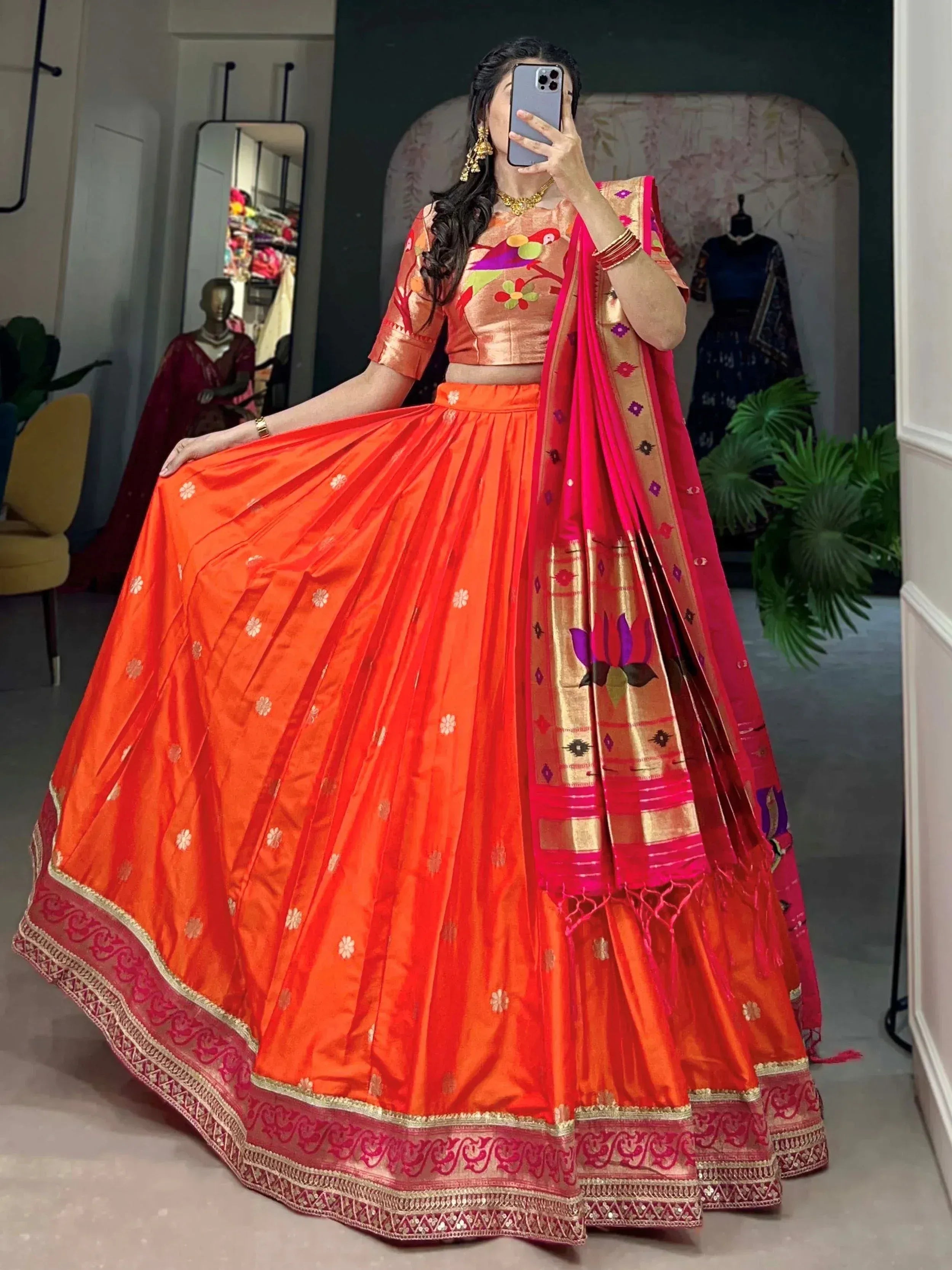 Vibrant orange lehenga choli with floral embroidery and pink dupatta, perfect for Indian ethnic occasions