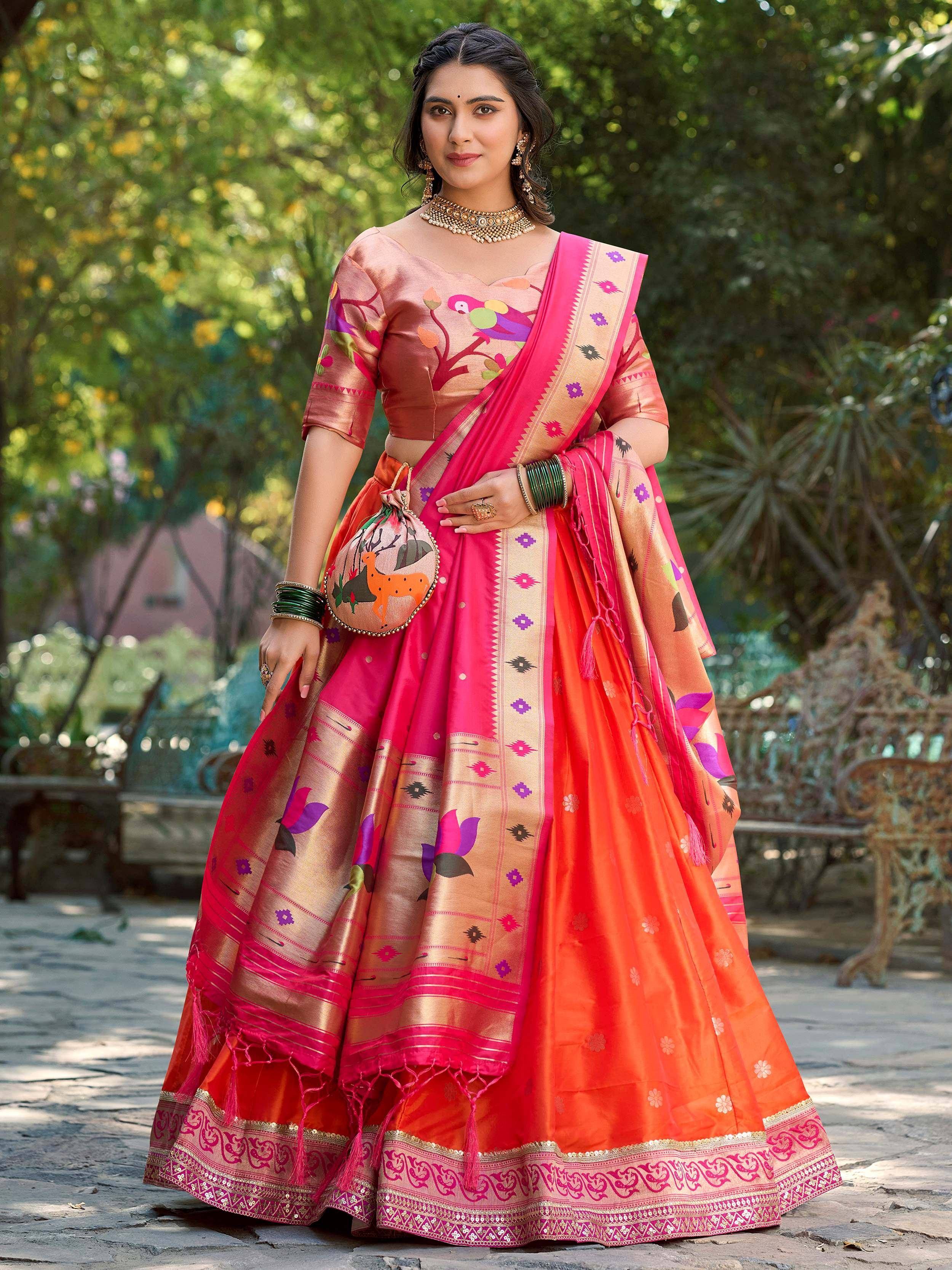 Vibrant pink and orange designer lehenga choli with floral and bird print, perfect for Indian ethnic occasions