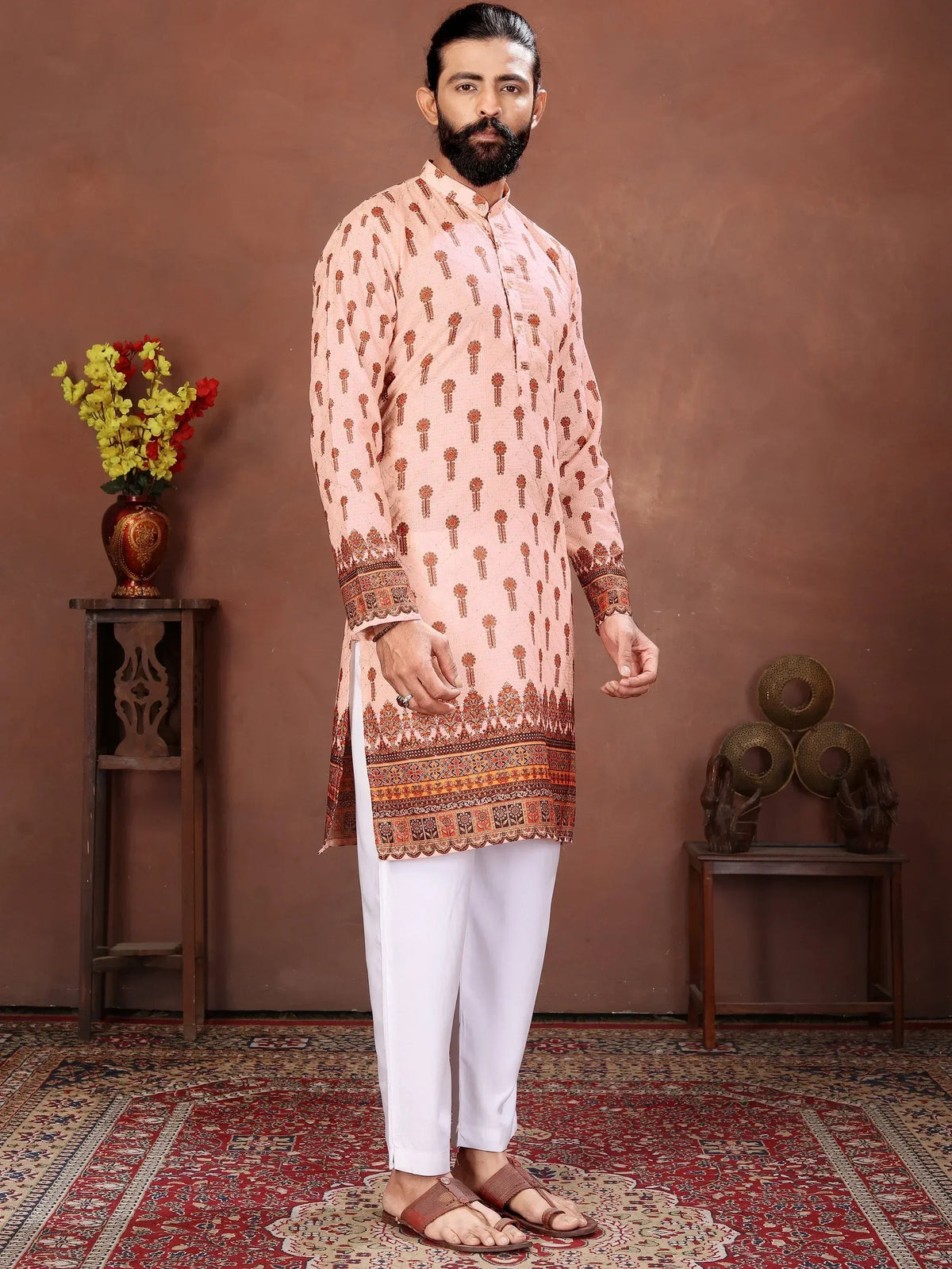 Man wearing a peach patterned ethnic kurta with white pajama pants