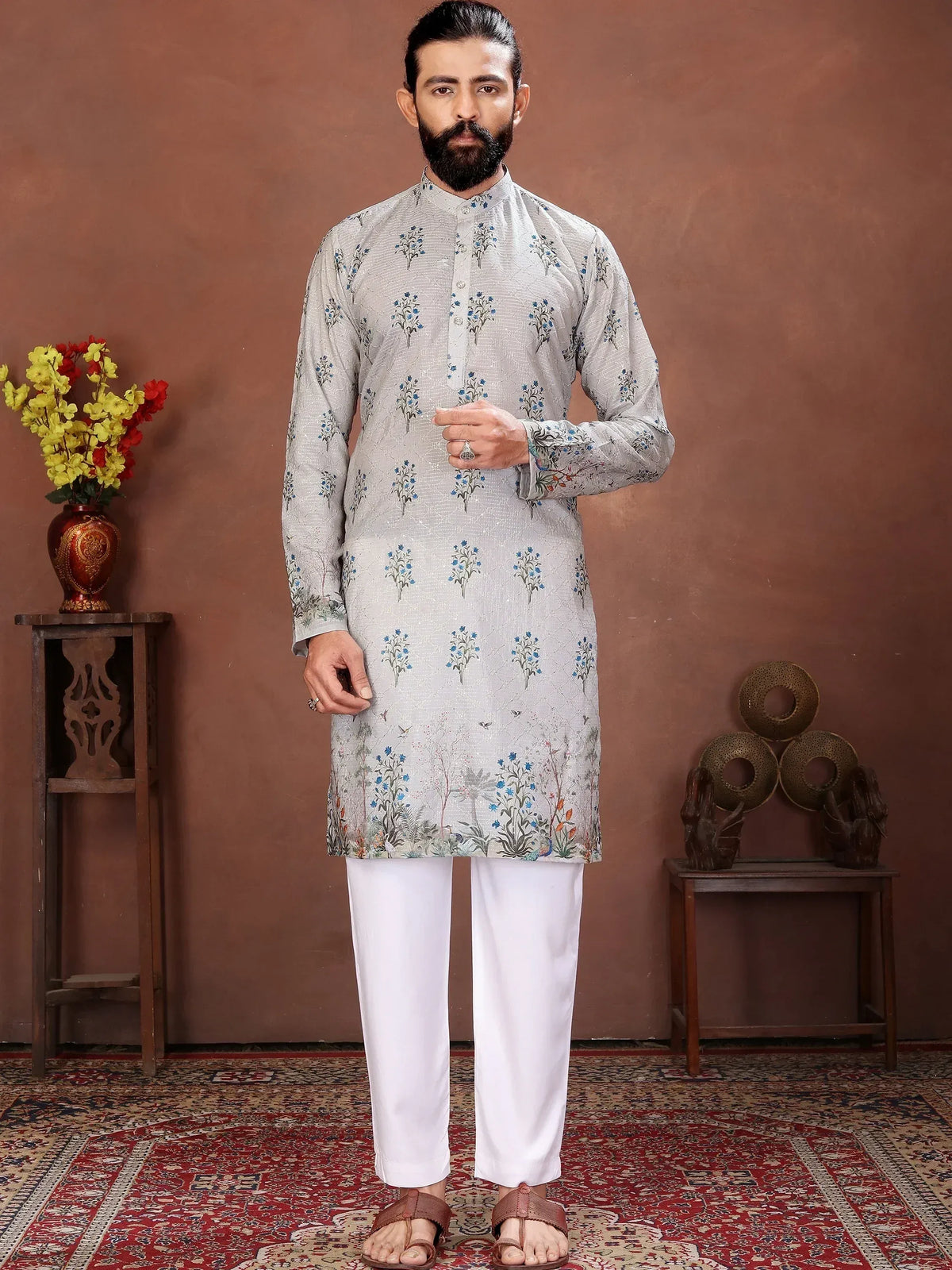Man wearing a grey floral print kurta with white trousers