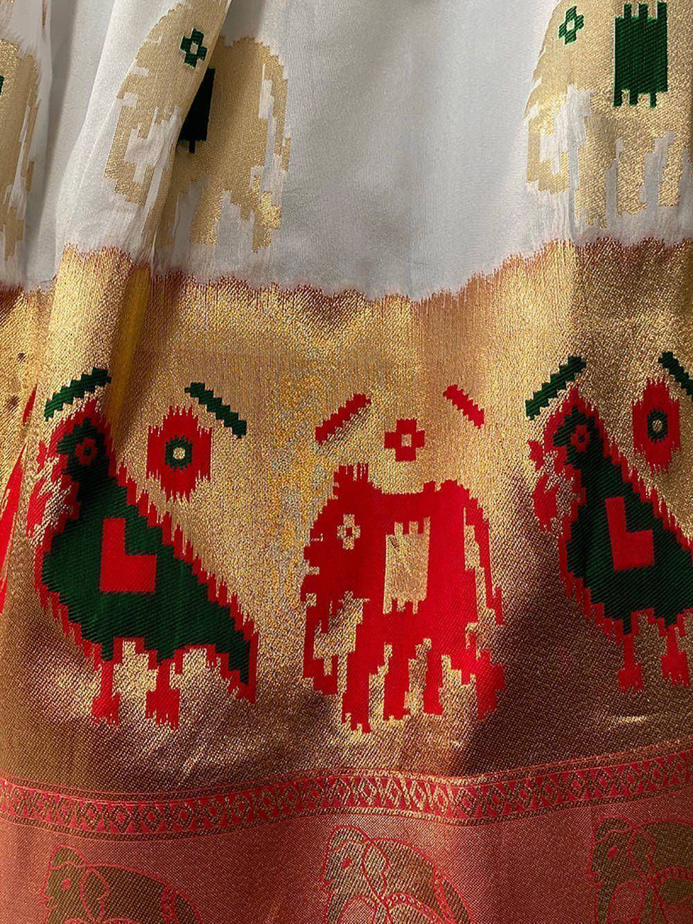Traditional Indian ethnic saree with vibrant red, green, and gold woven motifs and elephant patterns