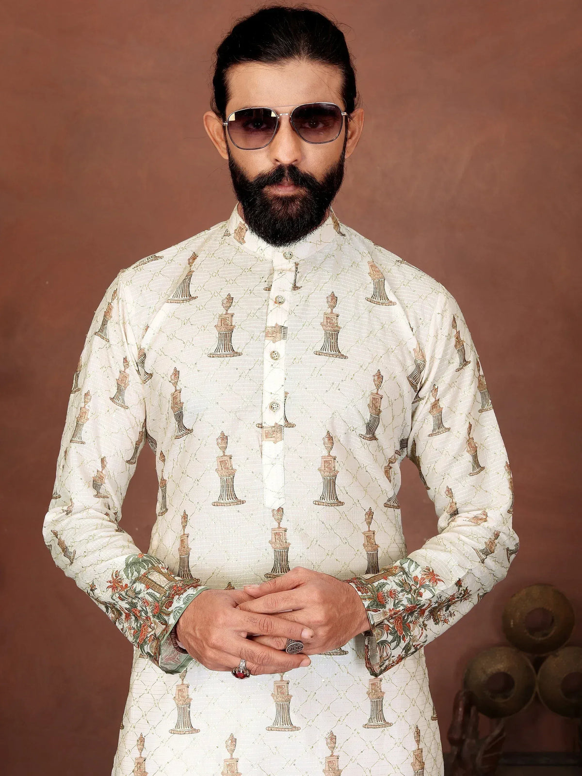 Man in a white printed ethnic kurta with floral cuffs and sunglasses