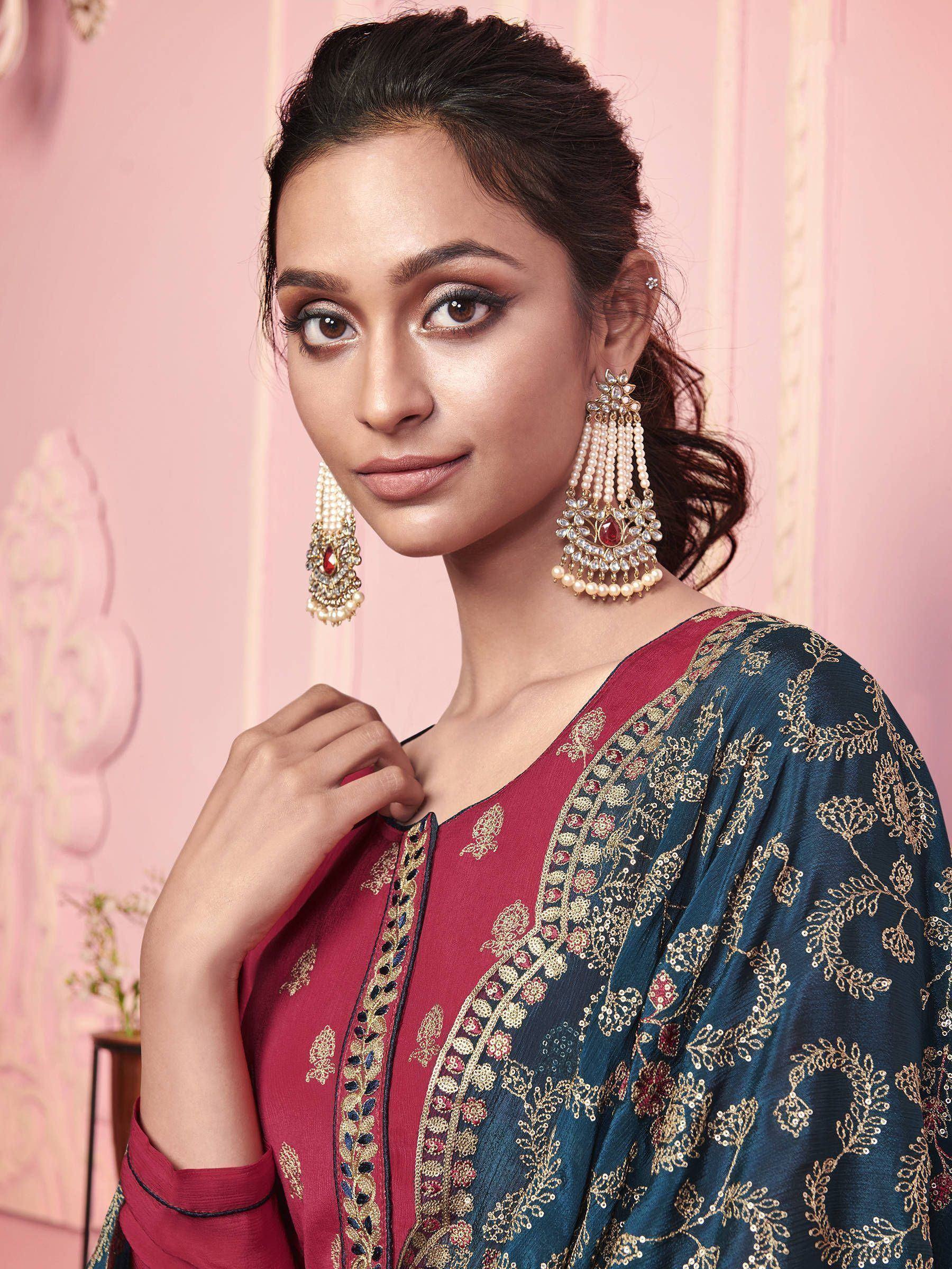 Elegant Indian ethnic wear with intricate embroidery and pearl earrings