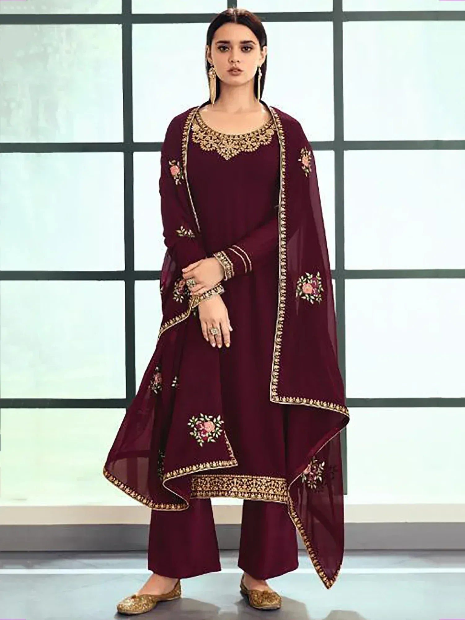 Maroon embroidered salwar kameez with floral motifs and gold detailing, perfect for ethnic occasions