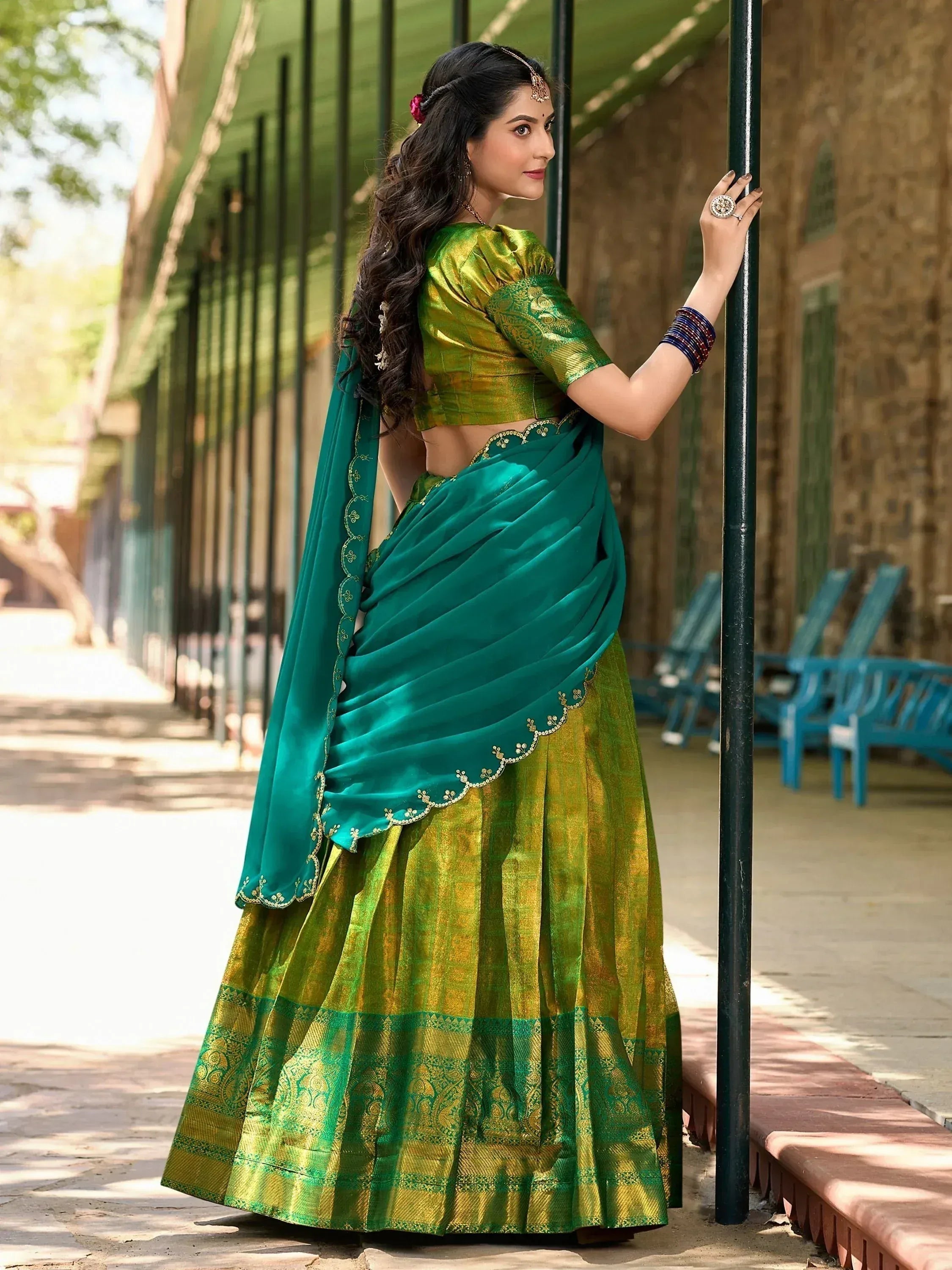 Elegant green and gold designer lehenga choli with embroidered dupatta, perfect for Indian ethnic occasions