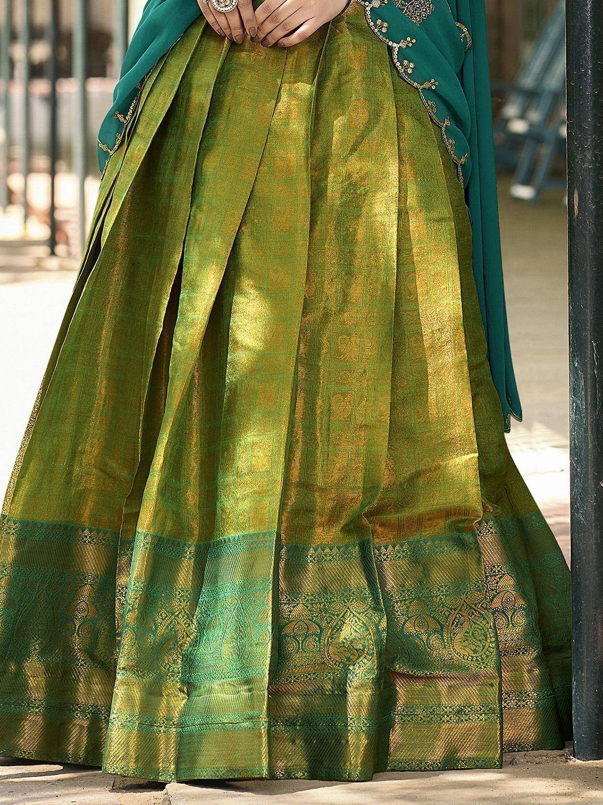 Green and gold embroidered lehenga choli with intricate border design, perfect for Indian ethnic wear