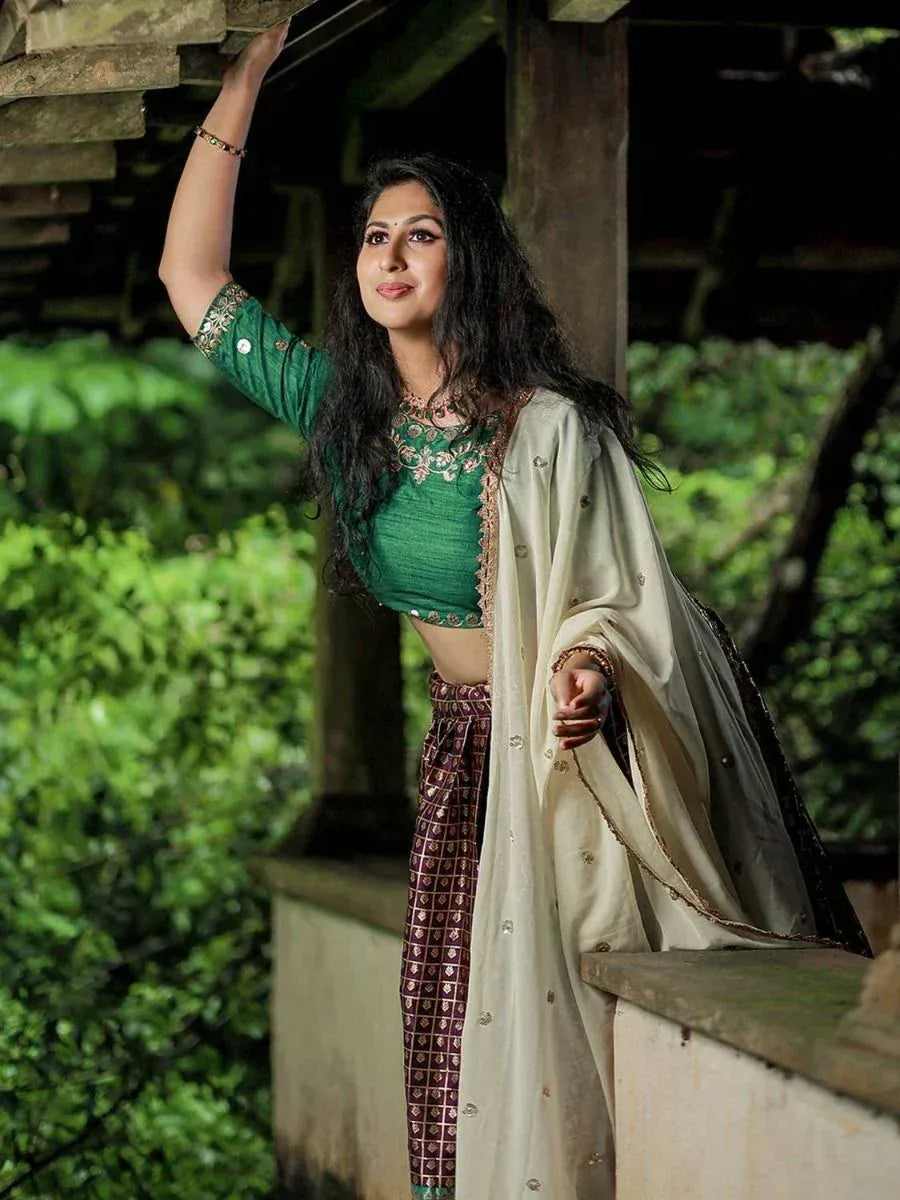 Woman in green embroidered crop top with patterned palazzo pants and cream dupatta, ethnic wear