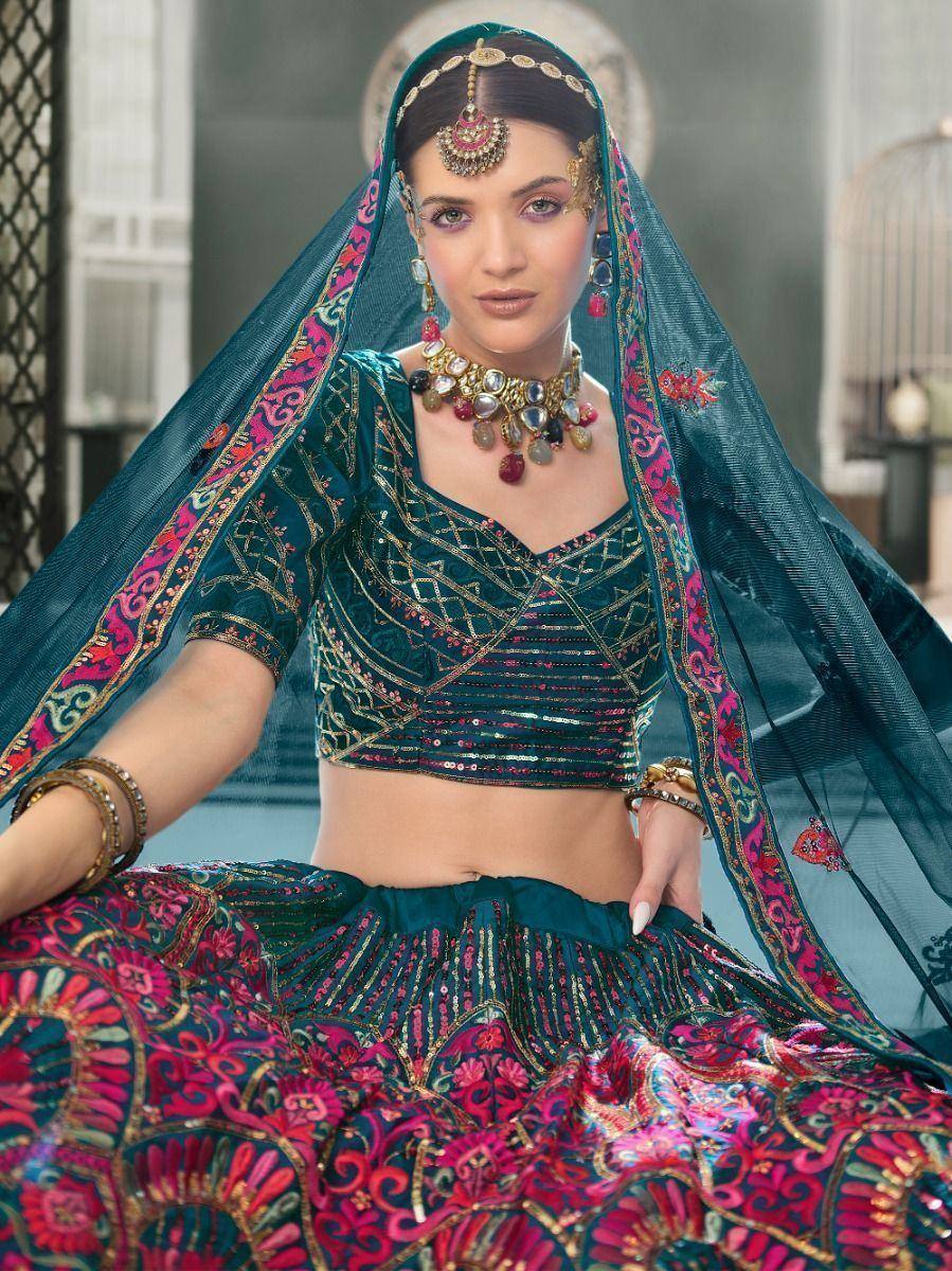 Teal and pink embroidered lehenga choli with matching dupatta, traditional Indian bridal wear