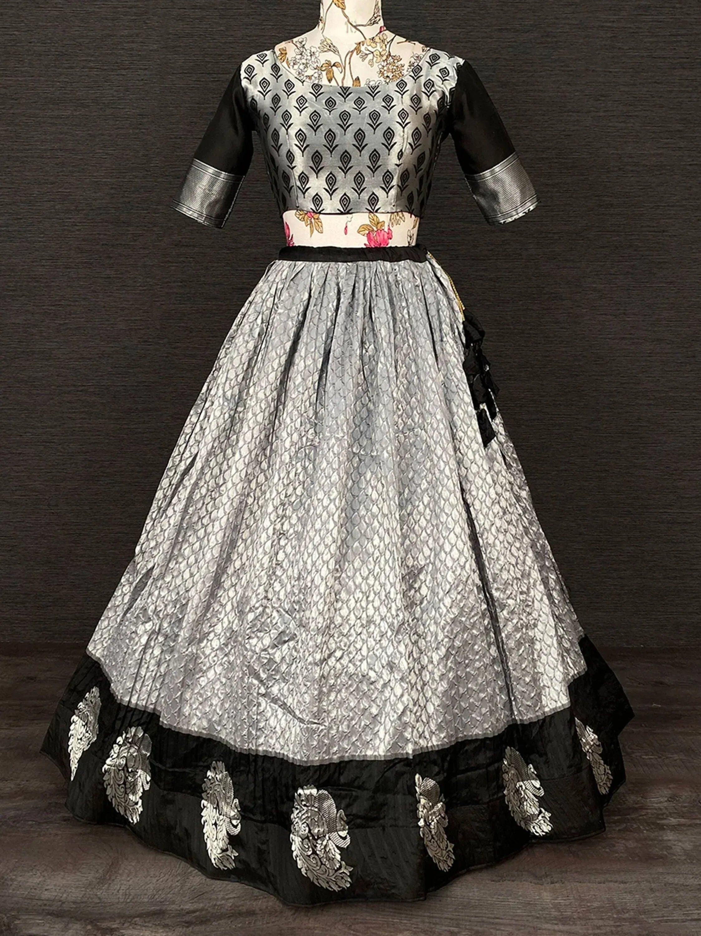 Black and silver designer lehenga choli with floral waistband and embroidered border, ethnic wear