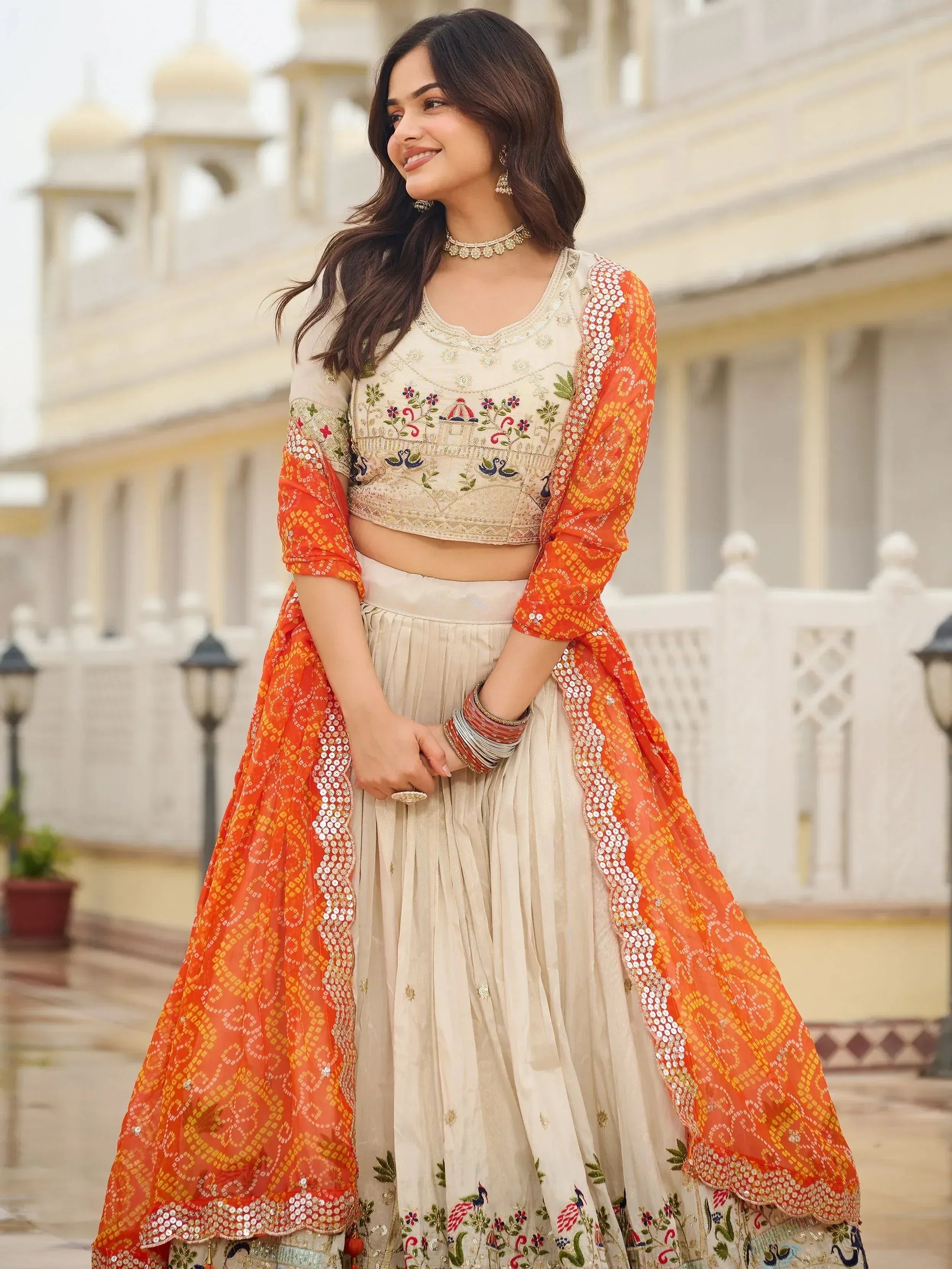 Majestic Off-White Sequnis Silk Lehenga Choli With Orange Dupatta